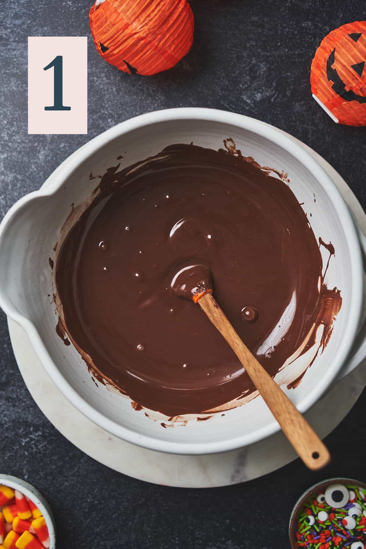 melted dark chocolate in a bowl with a rubber spatula. 