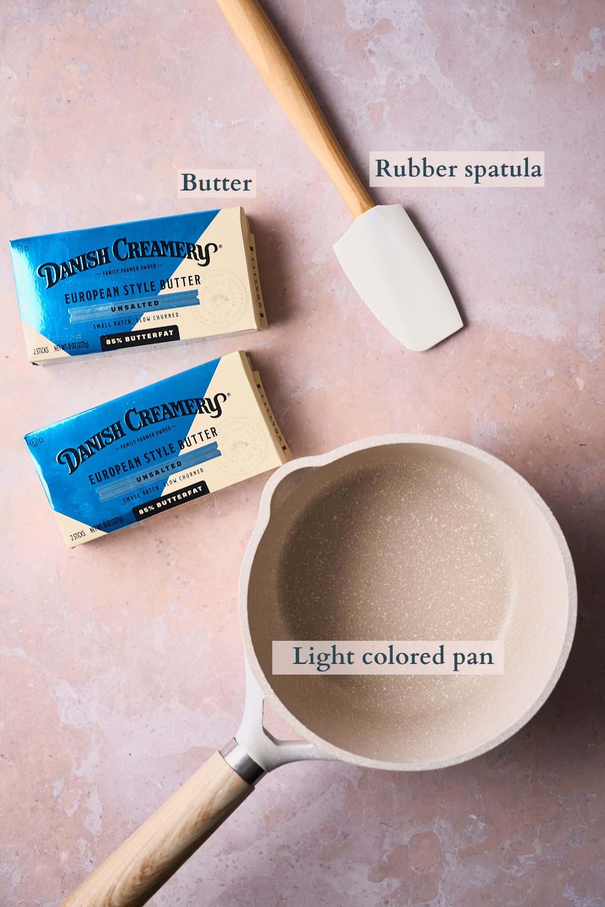 Ingredients and tools needed to make brown butter laid out on a table and labeled. 
