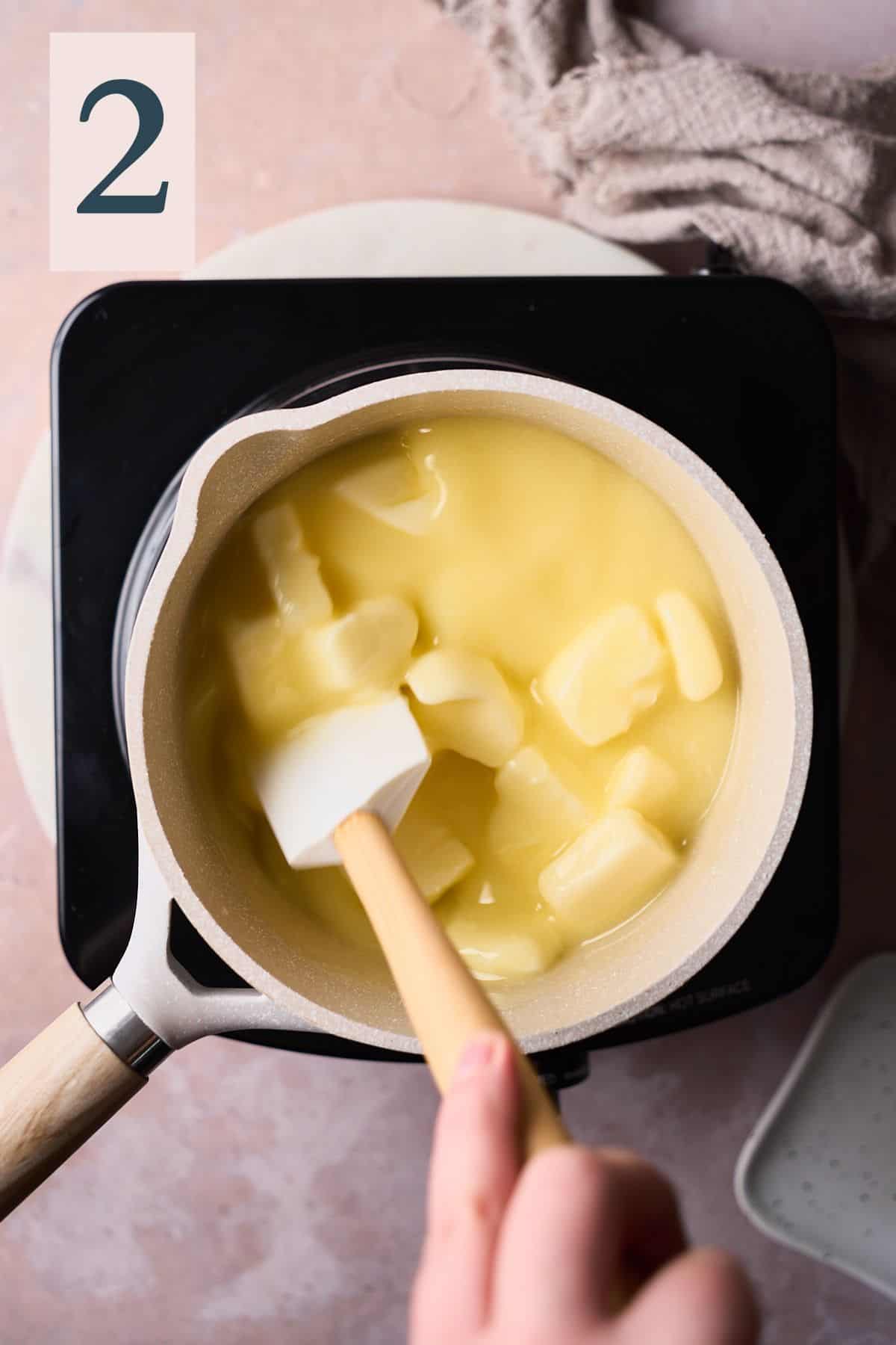 rubber spatula in a saucepan with butter melting. 