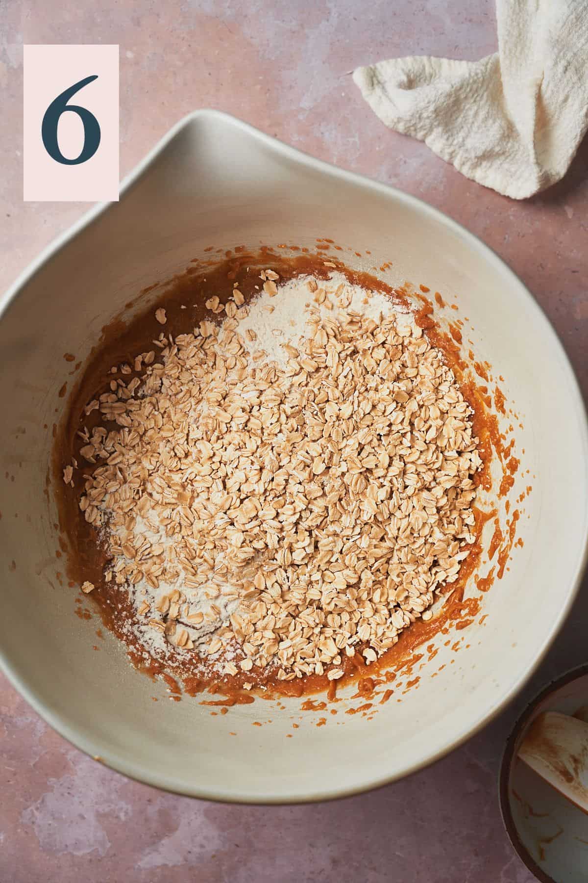 oats and flour in a large mixing bowl with peanut butter and other wet ingredients. 