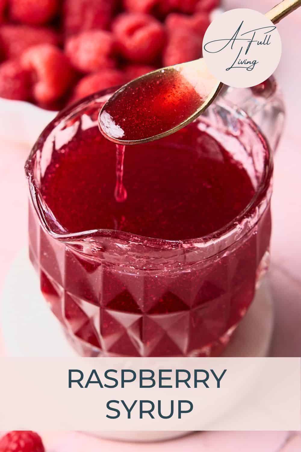 Thick raspberry syrup for cakes, pancakes, and drinks held on golden spoon.
