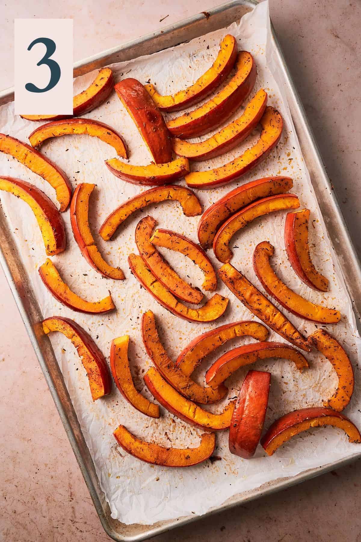 Pumpkin wedges baked at 425°F degrees and fully cooked on a parchment lined baking sheet.