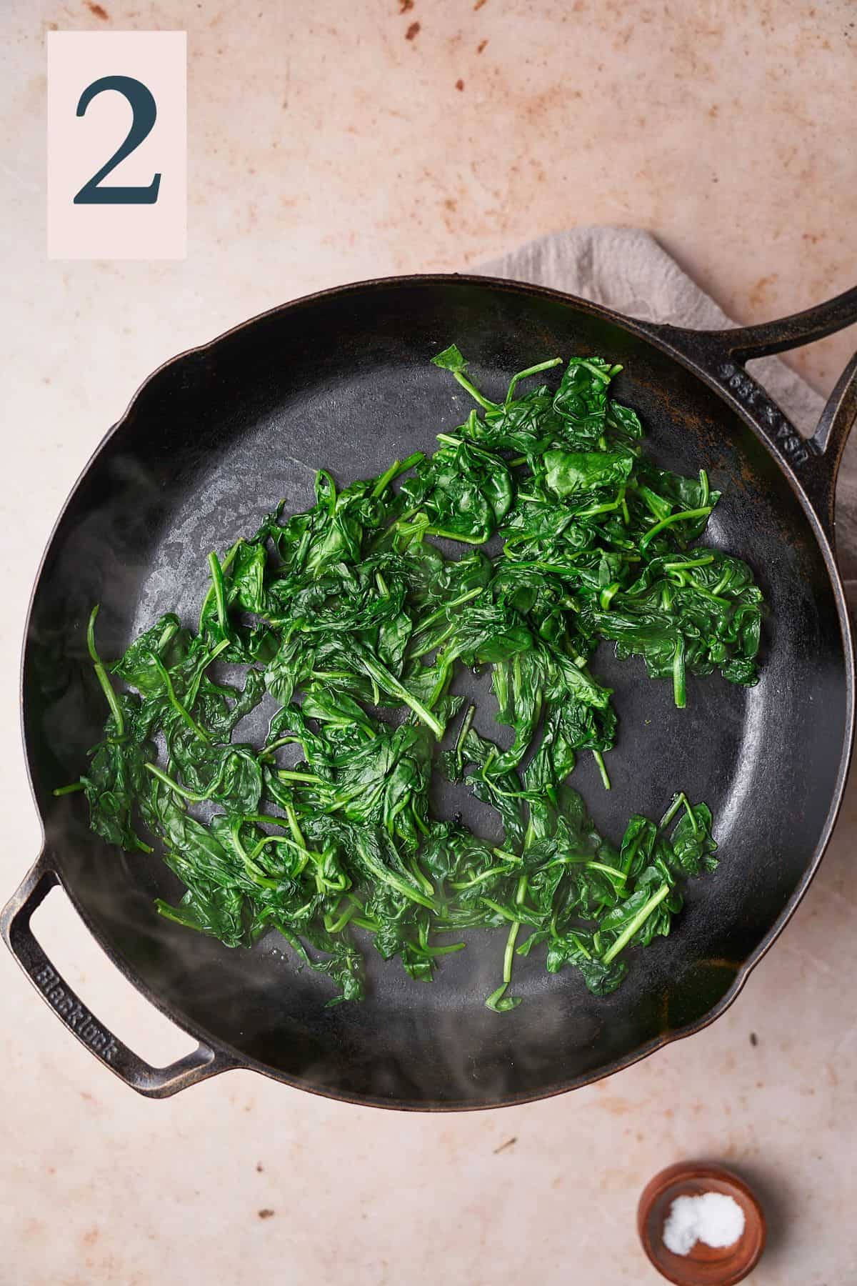 wilted spinach in a pan. 