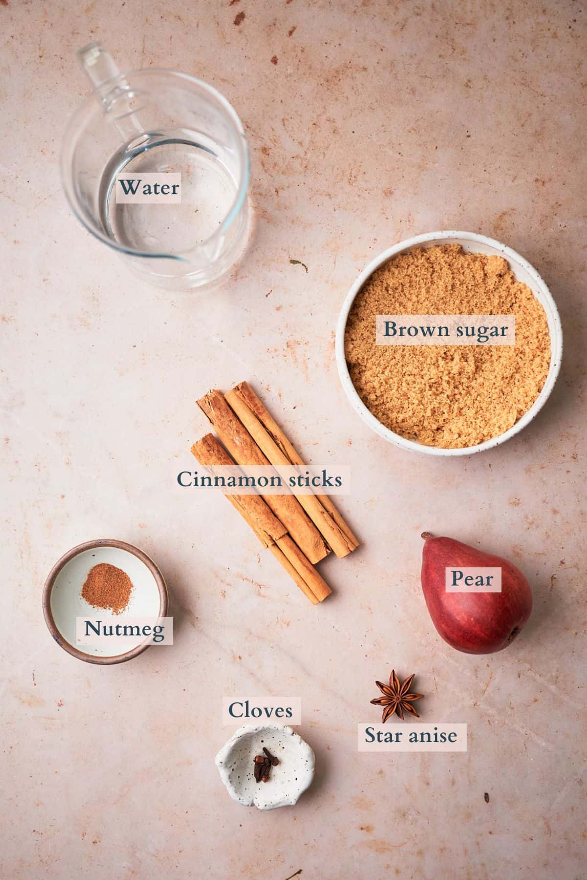 ingredients to make spiced pear simple syrup laid out and labeled to denote each ingredient. 