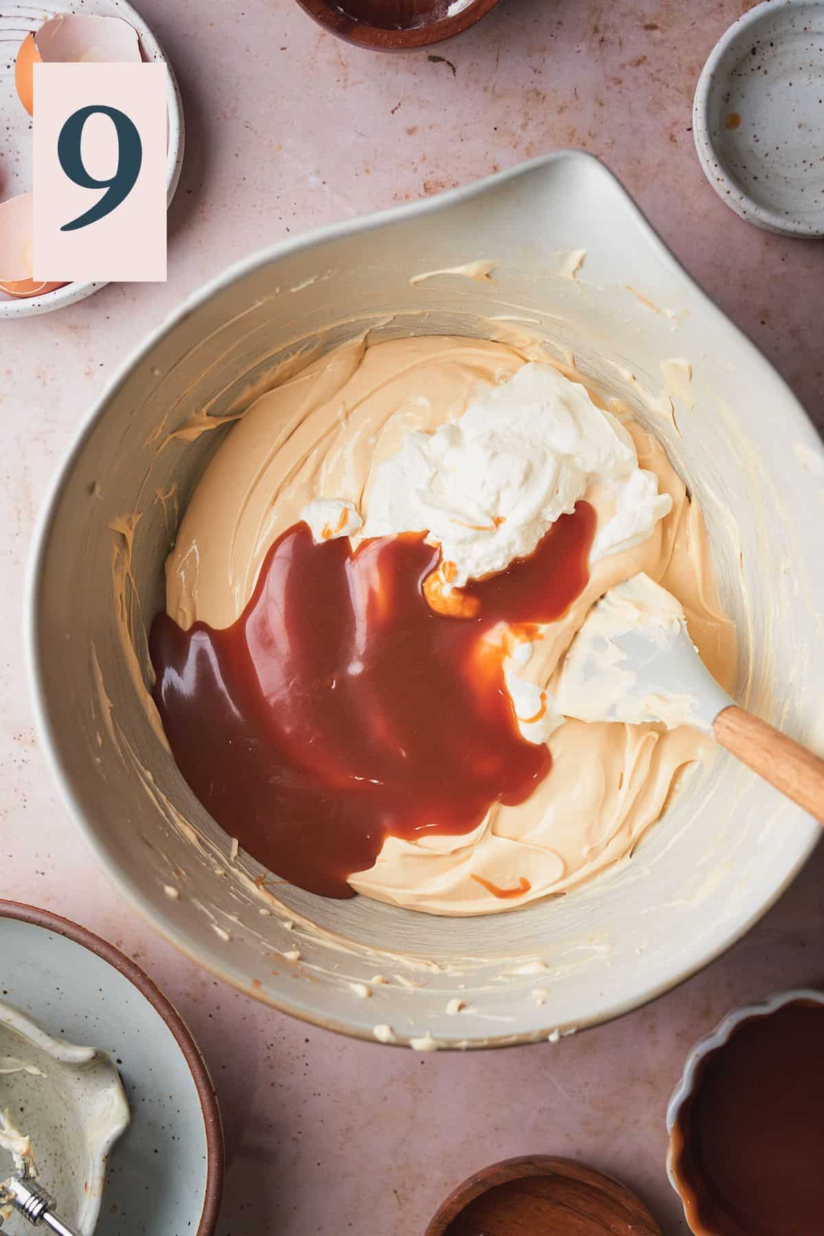 salted caramel and sour cream added to a cheesecake batter with a rubber spatula. 