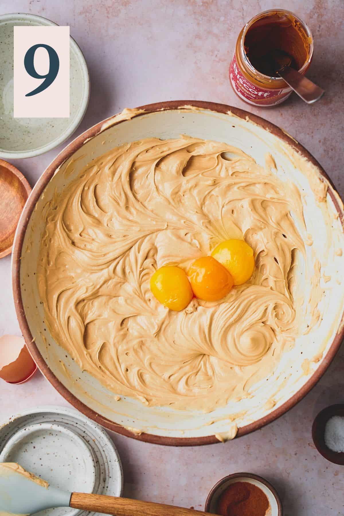 creamy cheesecake base with egg yolks in a large bowl. 