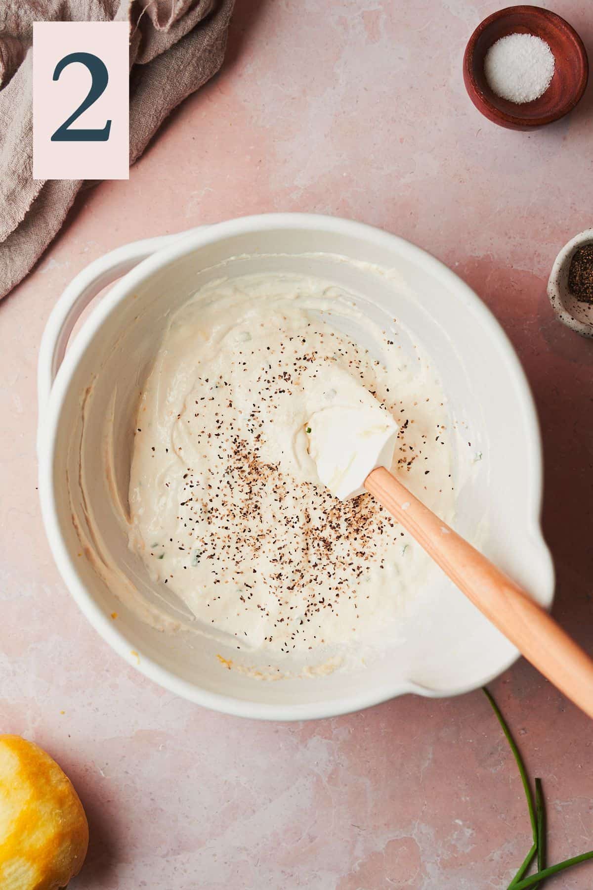 creamy horseradish sauce mixed together with salt and pepper added to the bowl with a rubber spatula.