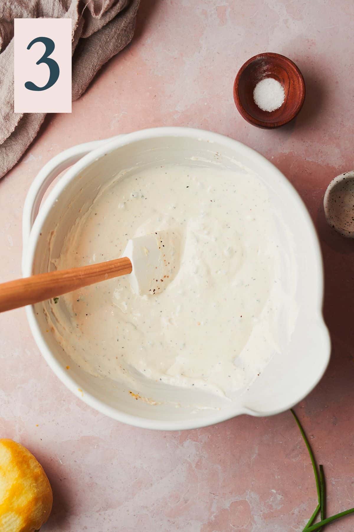 creamy horseradish sauce stirred together in a bowl with a rubber spatula.