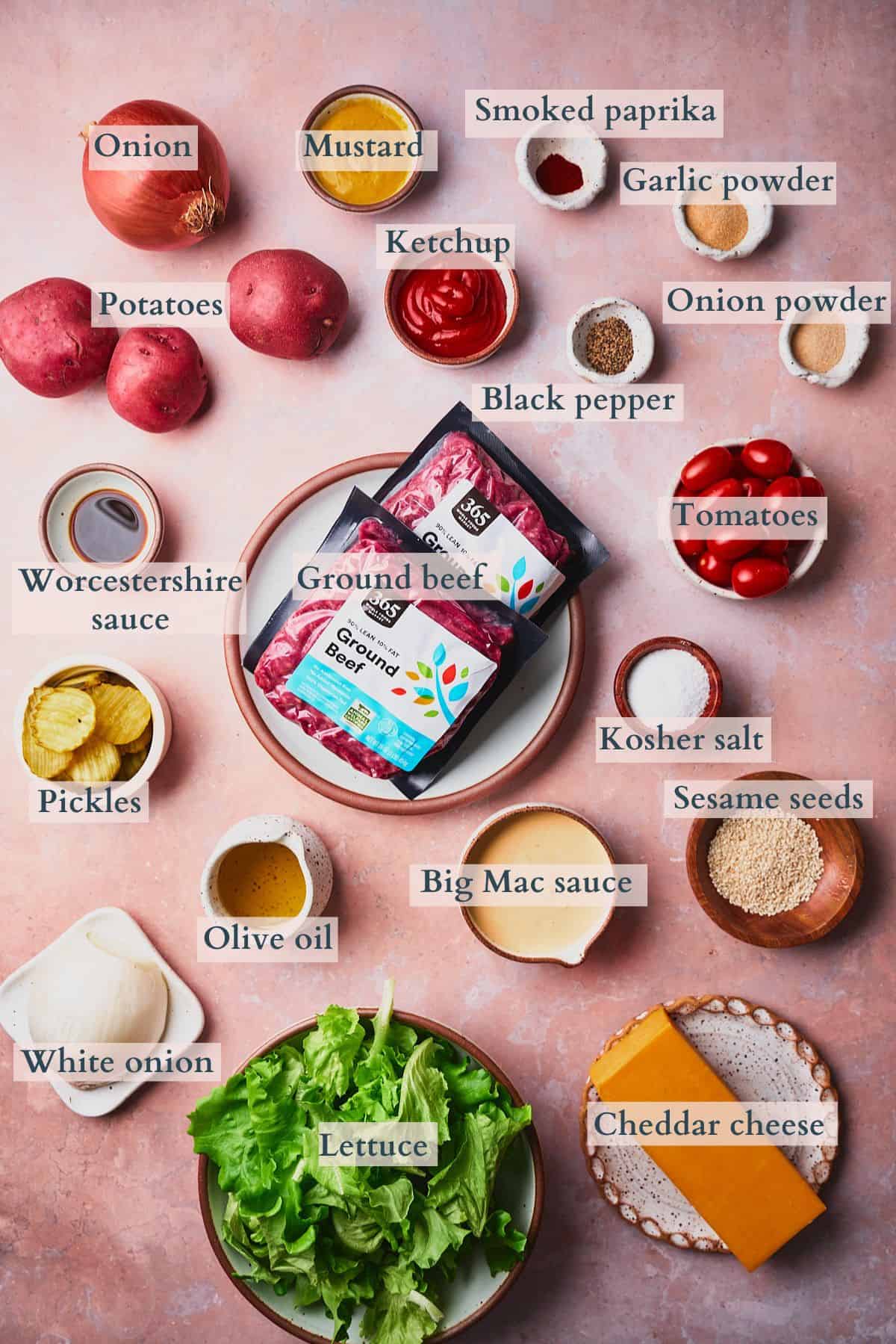 Ingredients to make big mac casserole laid out on a table labeled to denote each ingredient. 