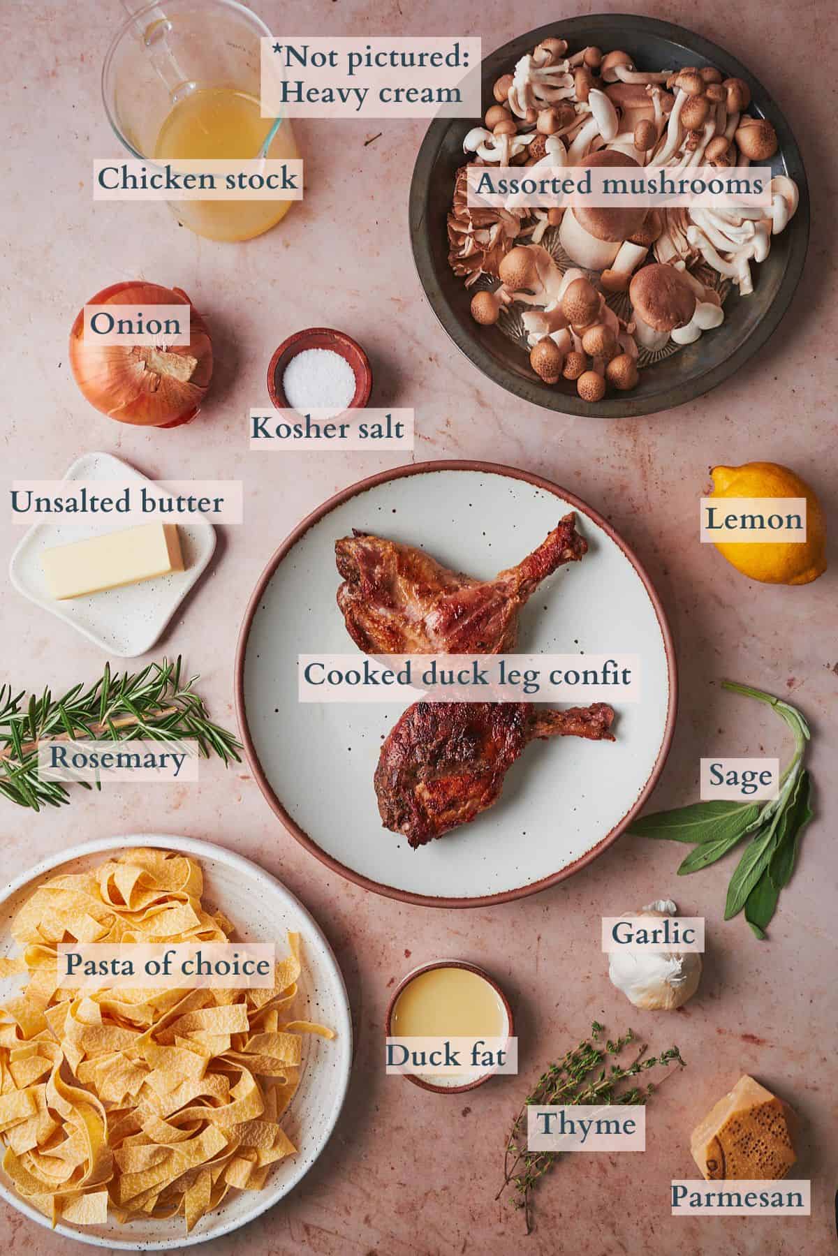 Ingredients to make duck pasta laid out on a table and labeled to denote each ingredient. 