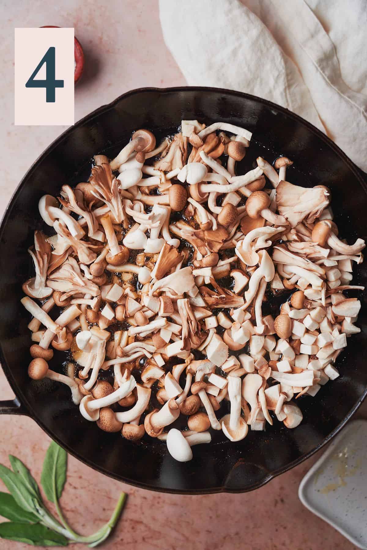 Raw mushrooms in a cast iron skillet. 
