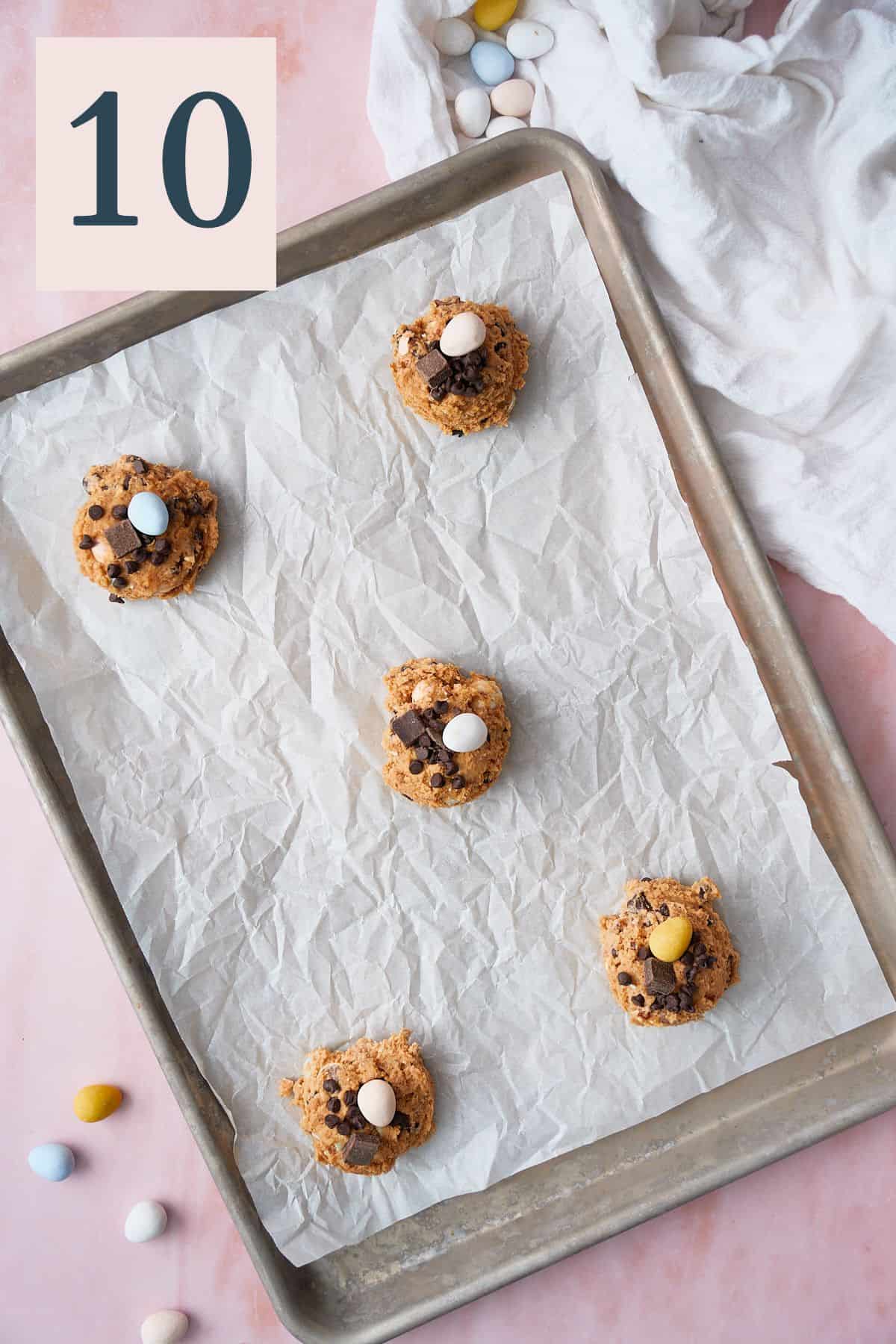 5 balls of cookie dough on a parchment lined baking sheet spread out to give them room. 