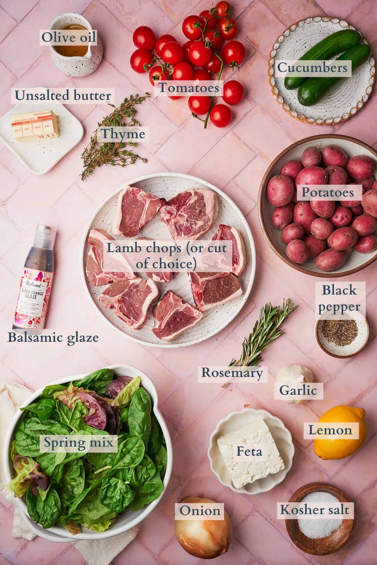 Ingredients to make a lamb salad laid out on a table and labeled to denote each ingredient. 
