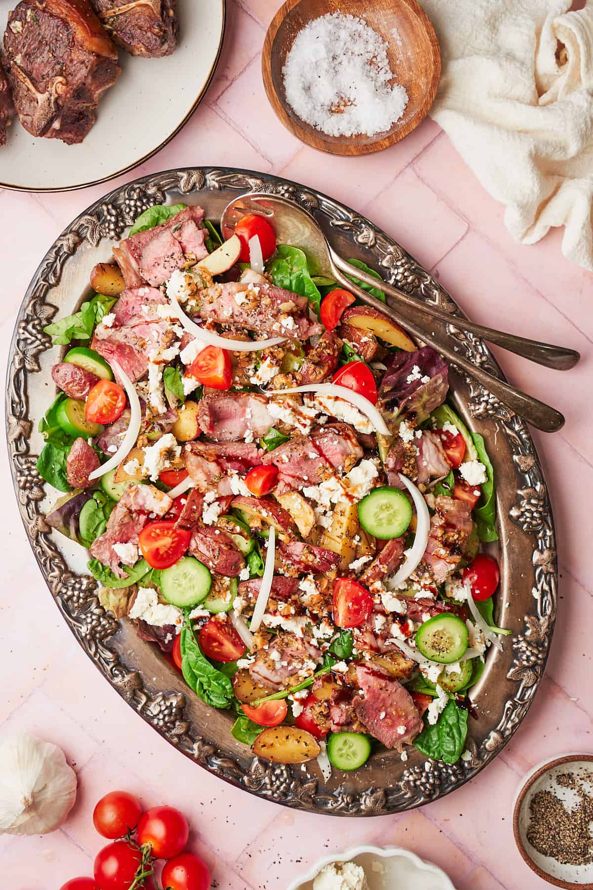 Flat lay of a large lamb salad with feta, tomatoes, cucumbers, and onion. 