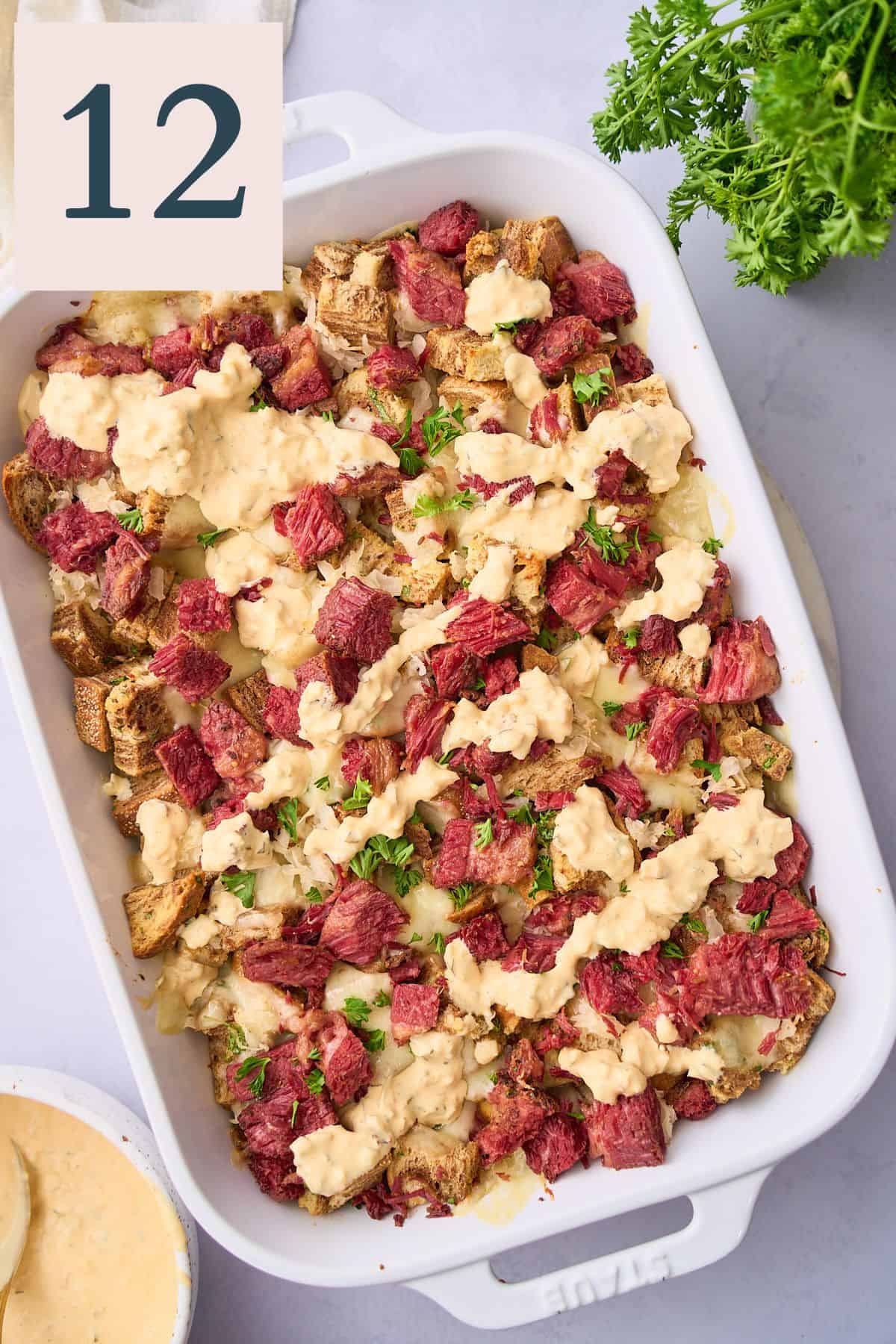 Reuben casserole baked and topped with reuben dressing. 