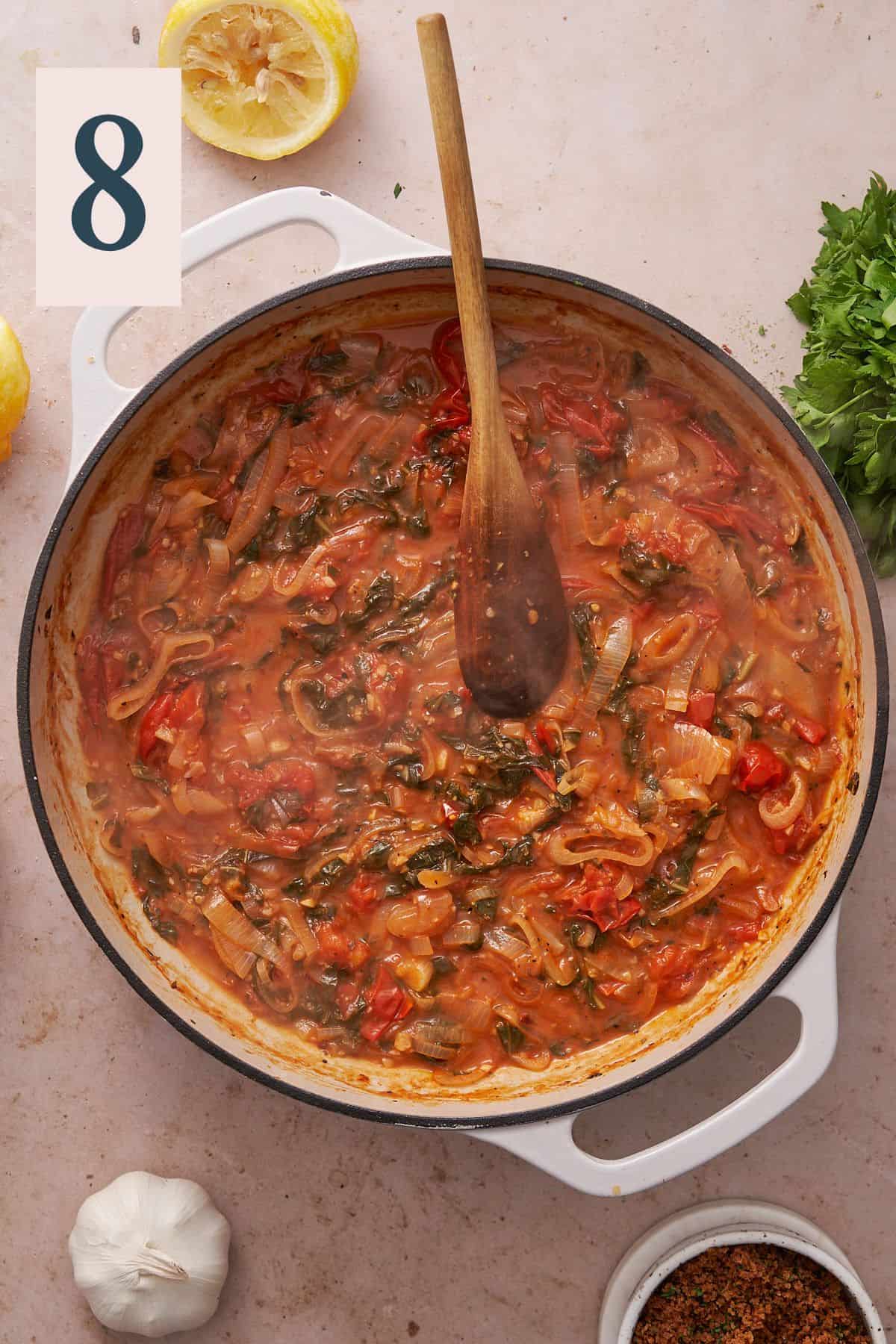 tomato sauce with shallots, garlic, seasonings, and fresh basil in a skillet.