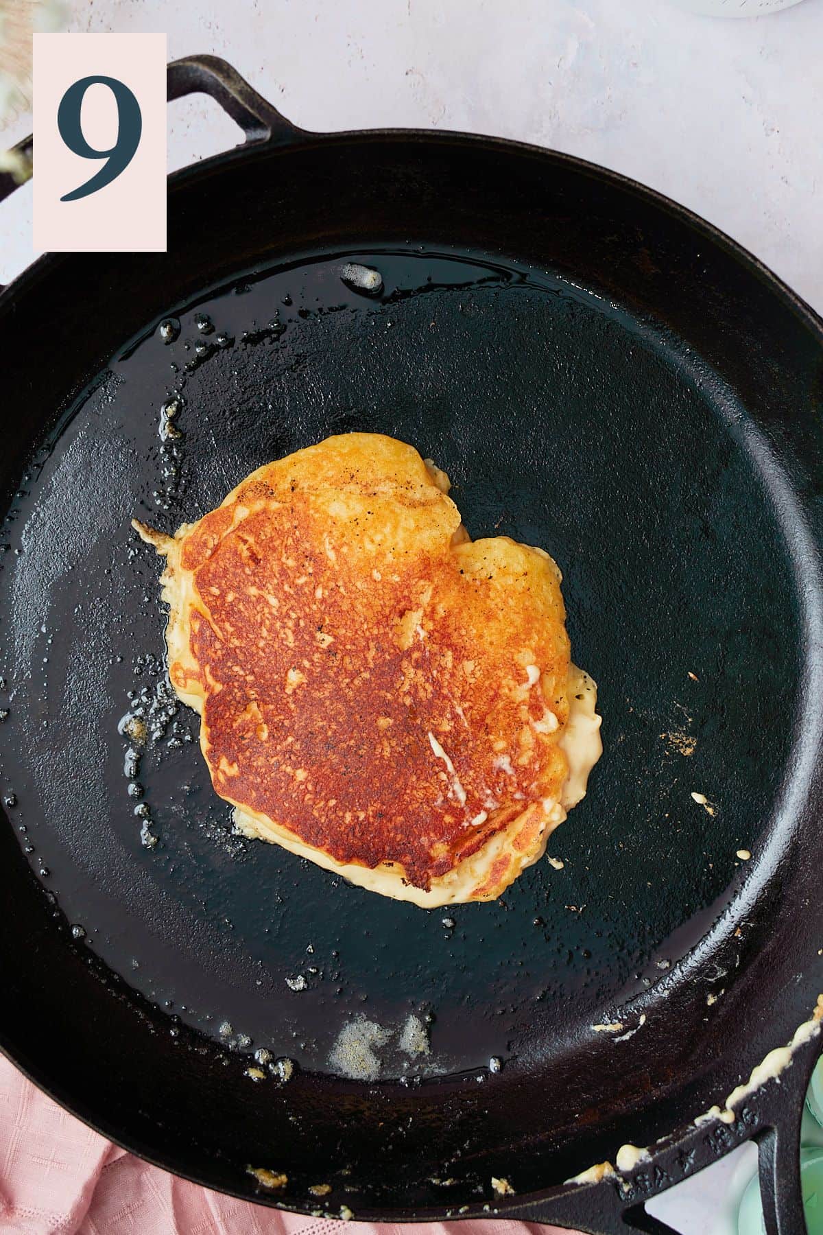 Golden brown pancake in a hot skillet. 