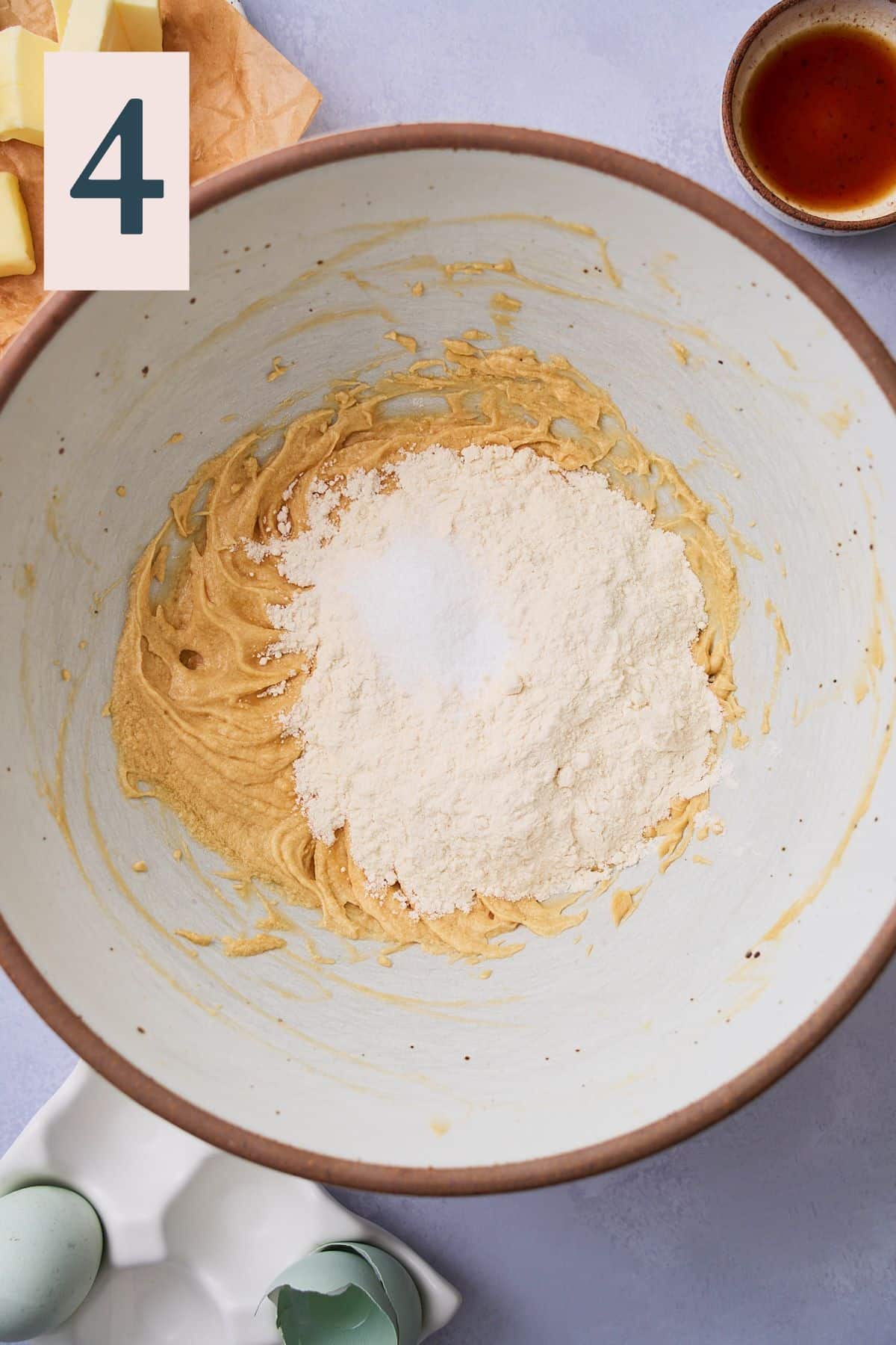 Flour, salt, and baking soda added to cookie dough in a bowl. 