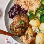 Norwegian Meatballs in Brown Gravy with broccoli, potatoes, lingonberries, and sauerkraut.