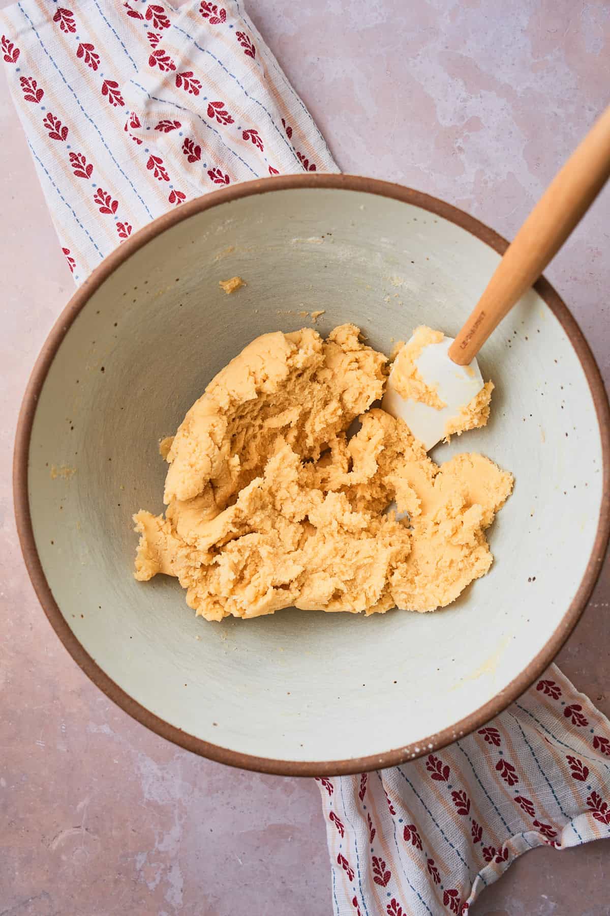 Dry ingredients mixed into the wet ingredients of the cookie dough in large bowl with a rubber spatula. 
