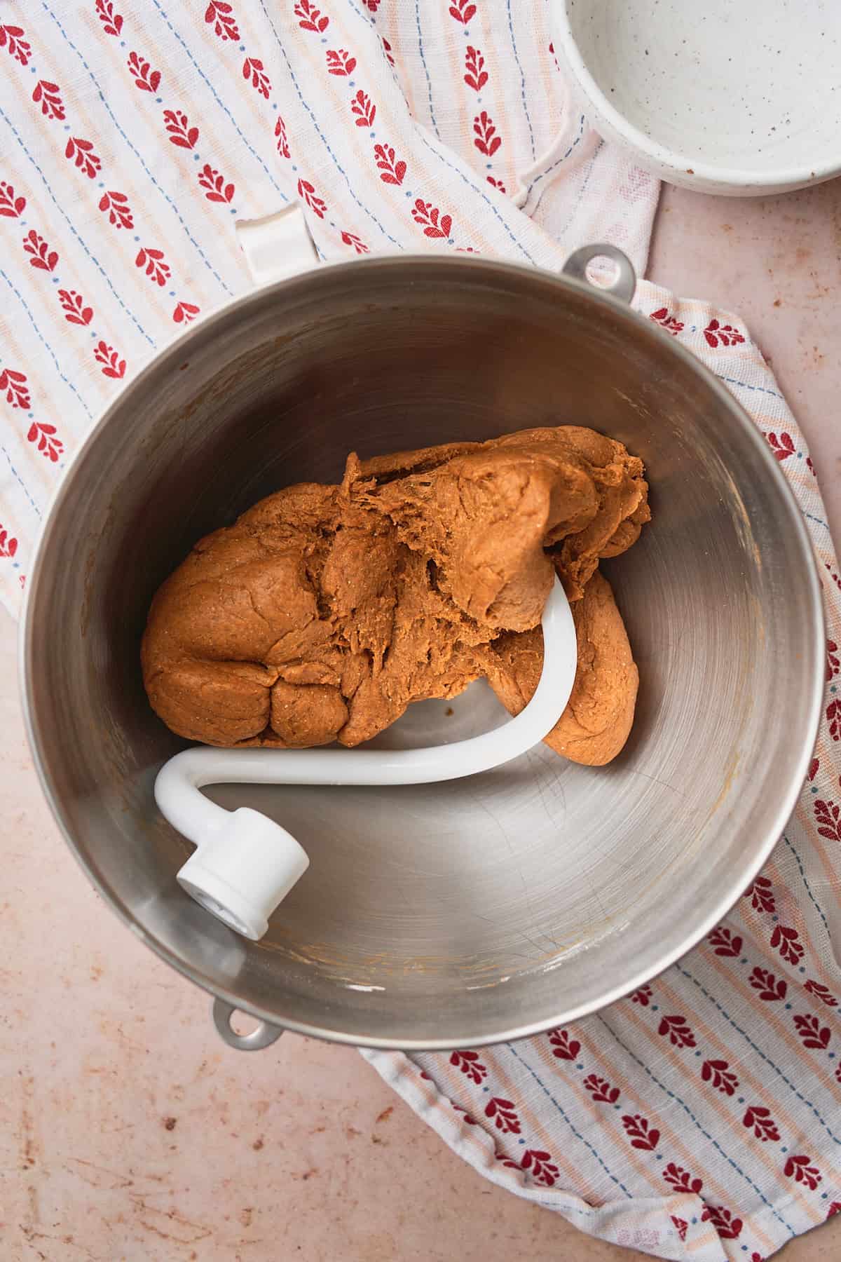 Rye bread dough in a large mixing bowl with a dough hook. 