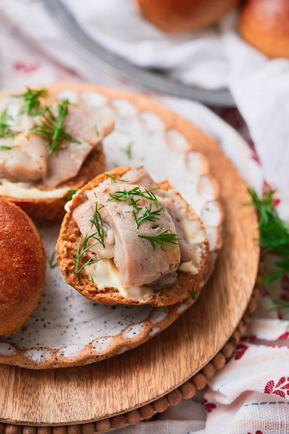 Soft and fluffy rye dinner rolls served with pickled herring and fresh dill.