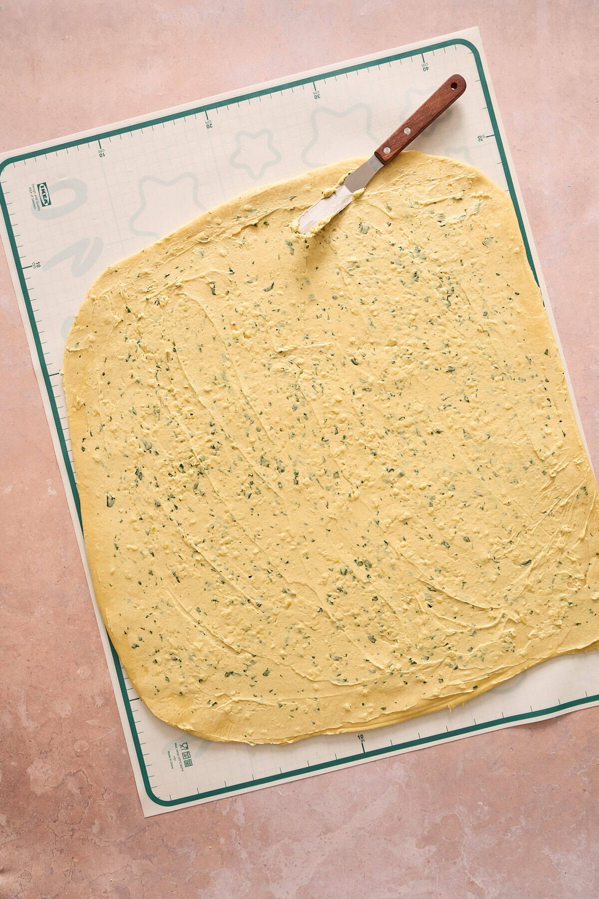Dijon garlic butter spread onto the dough using an offset spatula. 