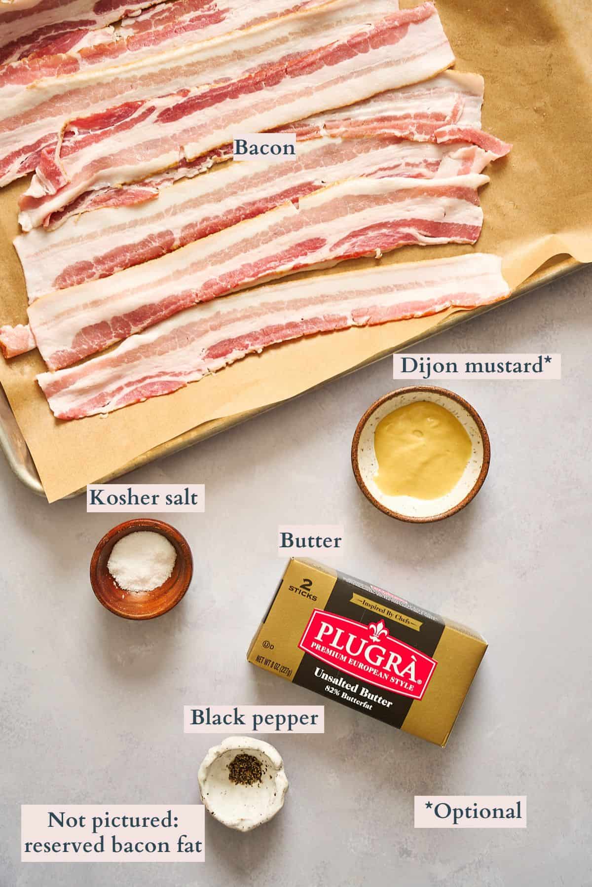 Ingredients to make bacon butter laid out on a table a labeled to denote each ingredient.