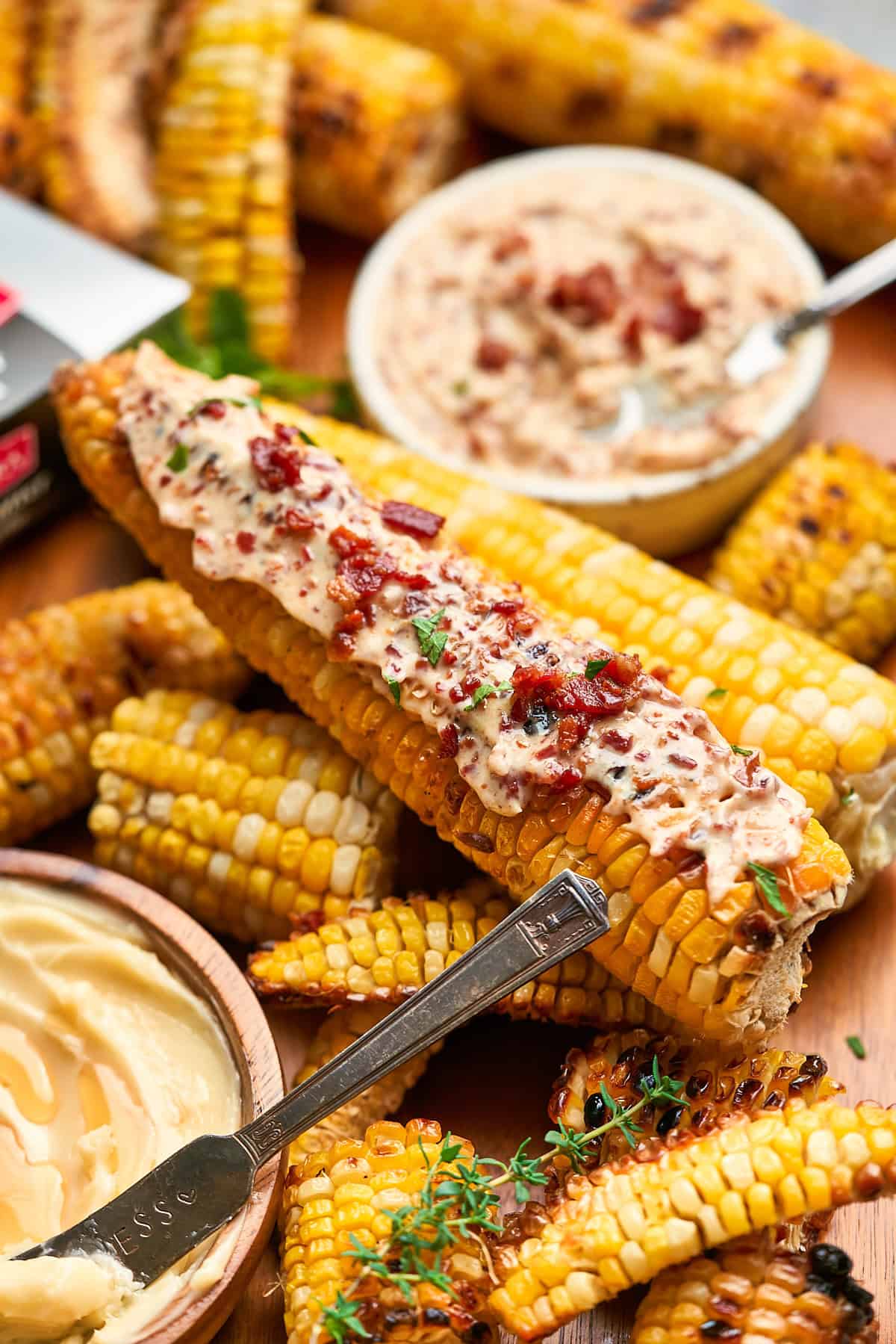 Corn on the cob topped with bacon butter and extra bacon crumbles.
