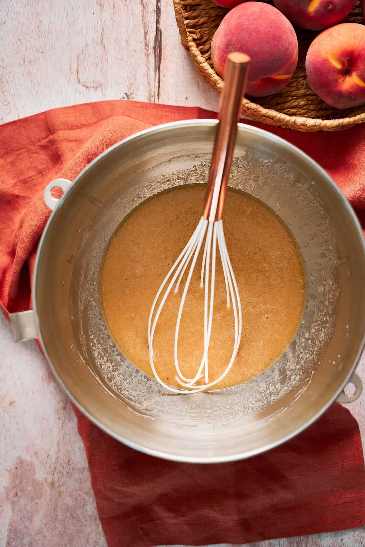Wet ingredients for cinnamon rolls whisked together in a large bowl.