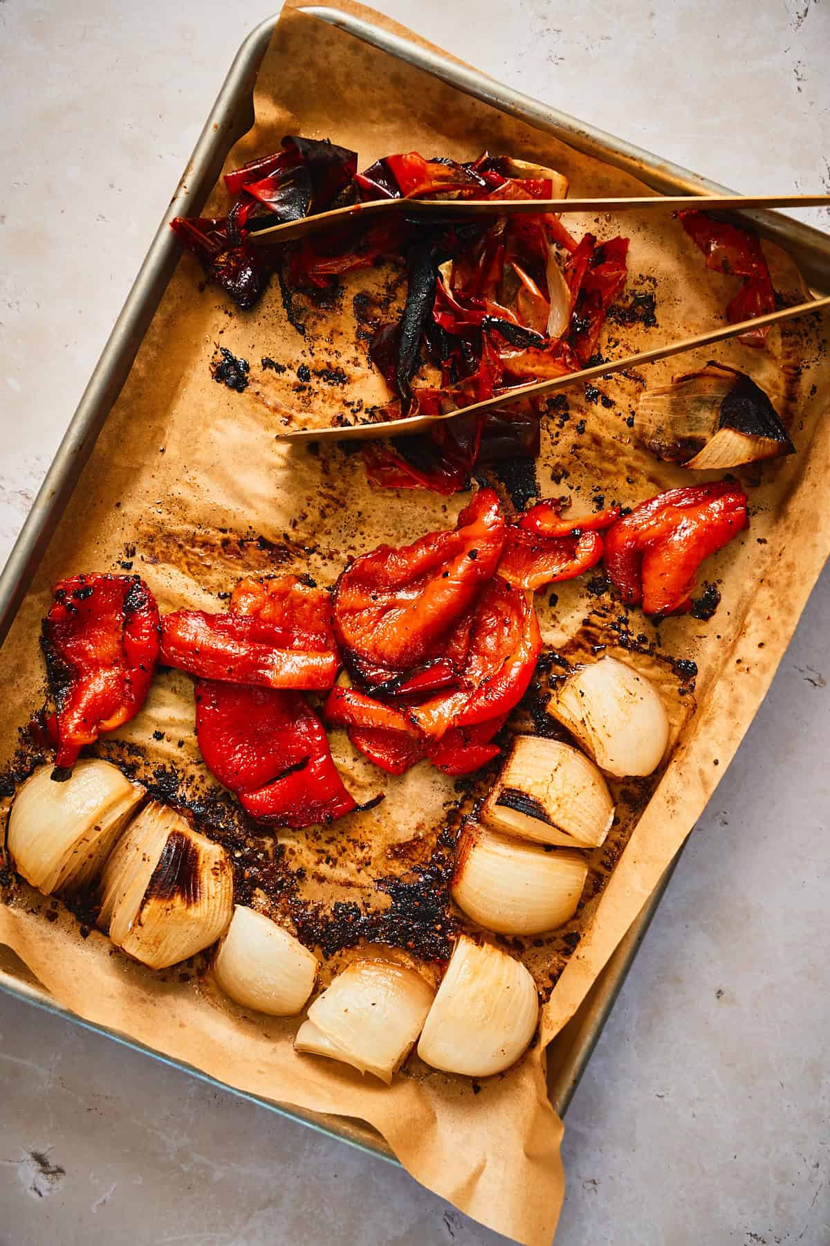 Peeling the papery  charred skin off of the red bell peppers
