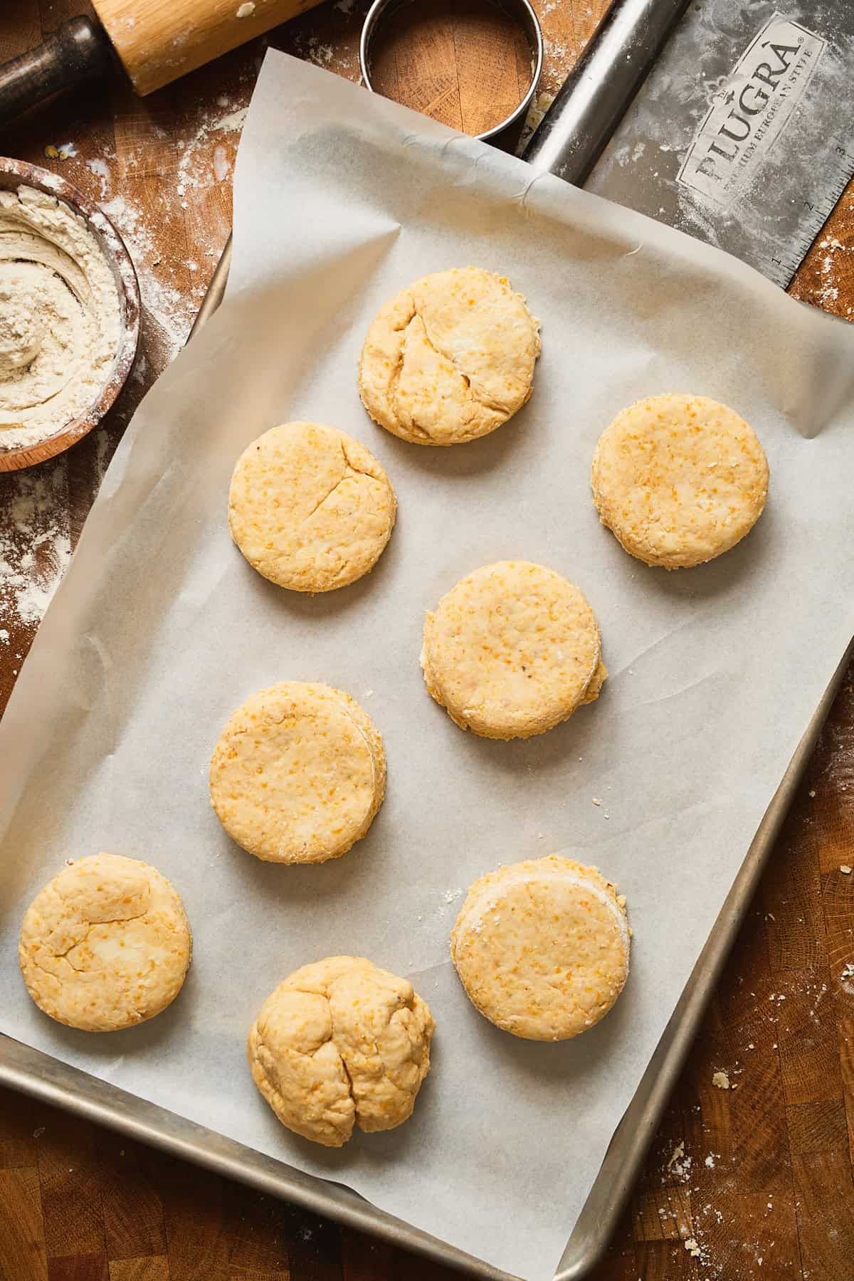 Buttery cornbread biscuits placed on baking tray with parchment paper before chilling and baking.