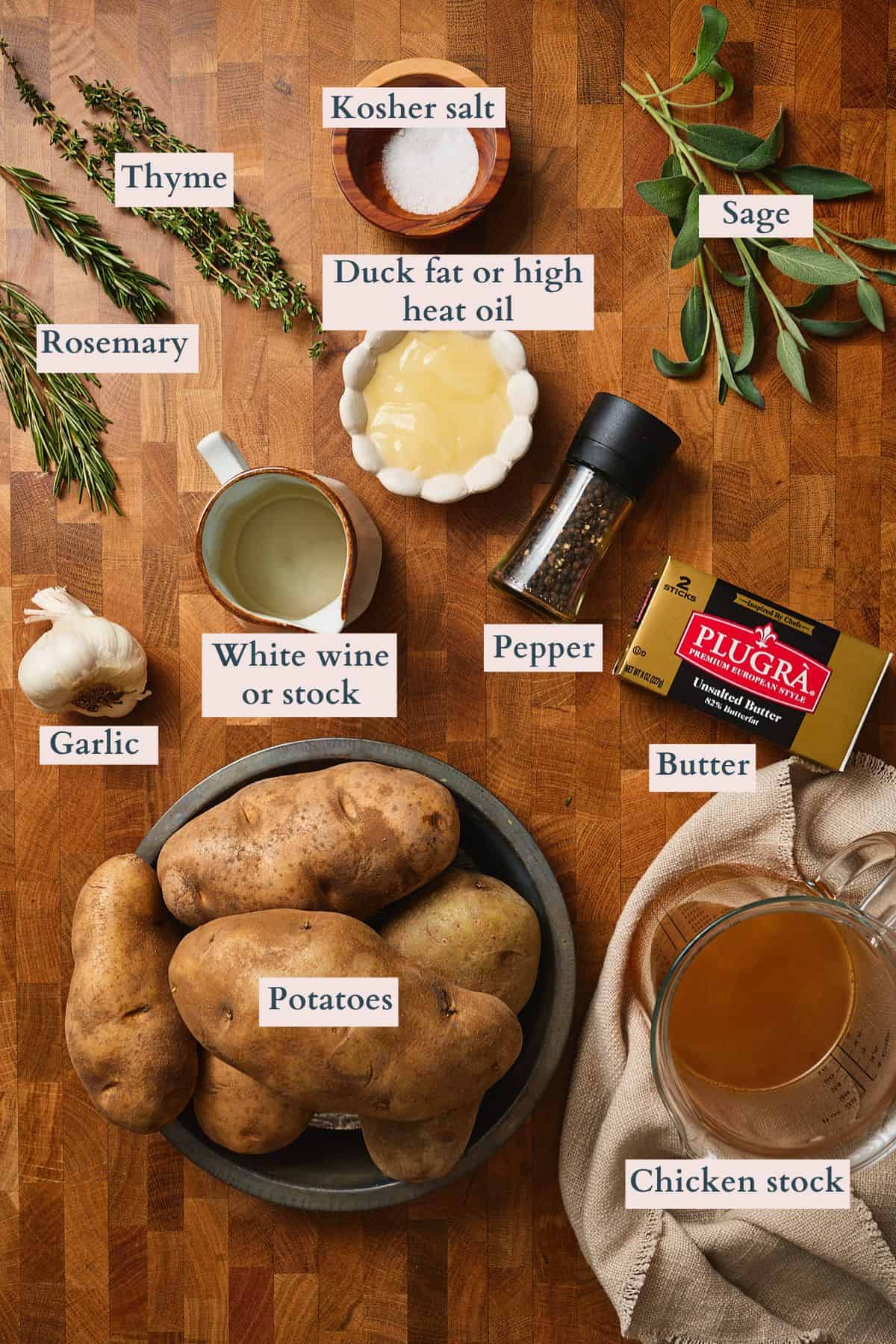 Fondant potatoes ingredients labeled on a wooden table.