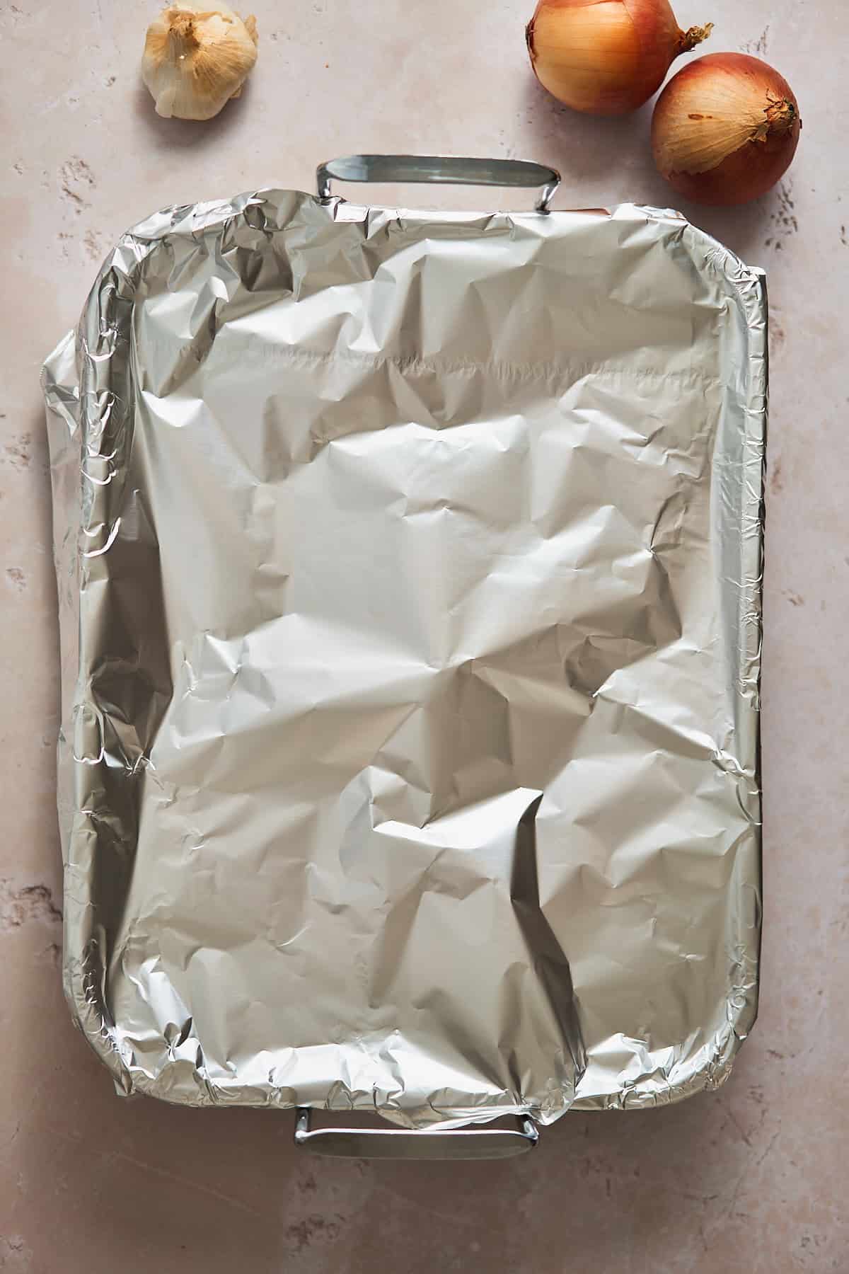 Roasting pan covered with foil before going into the oven.