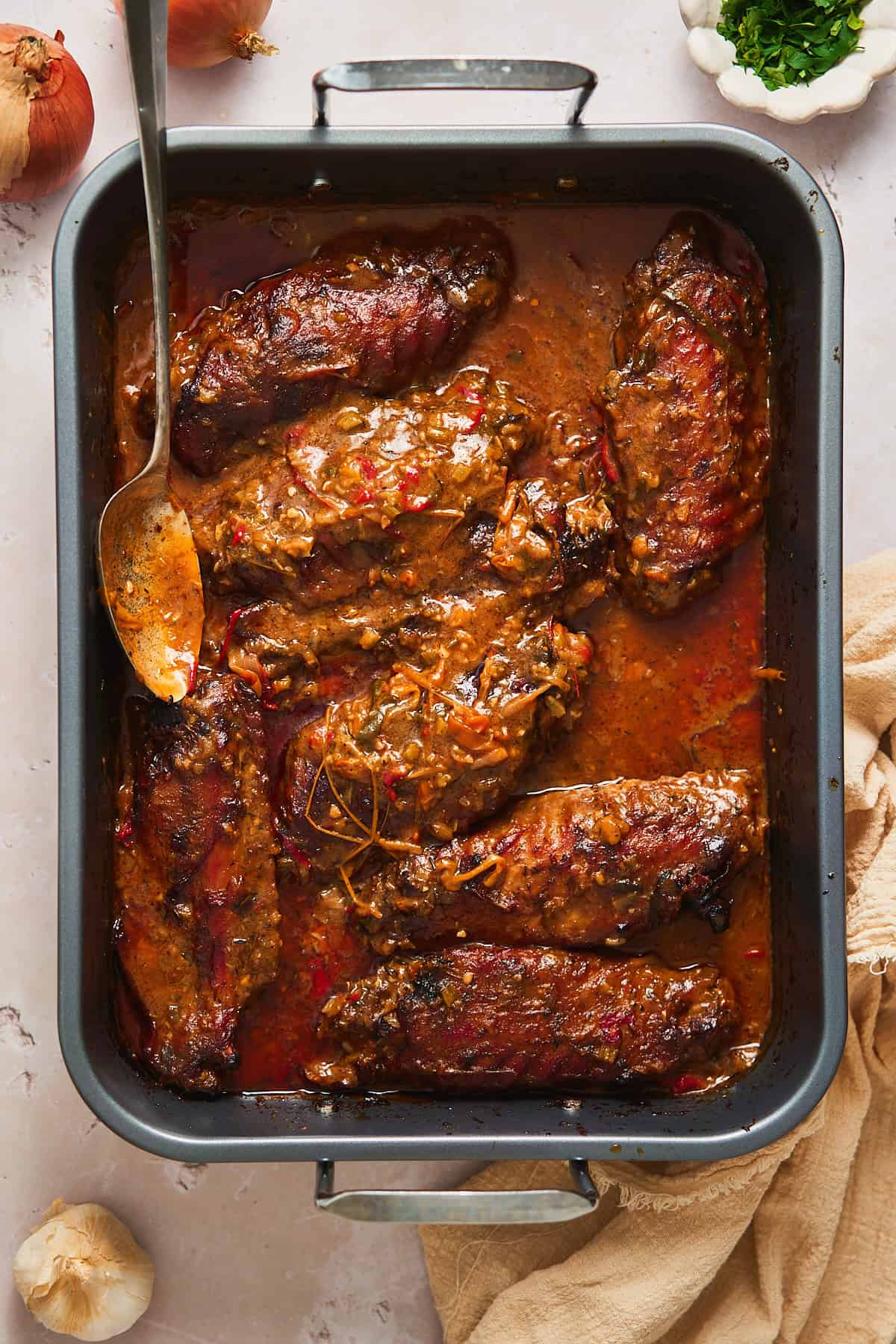 Turkey wings roasted to perfection in a rich, luscious and flavorful gravy in a large roasting pan.