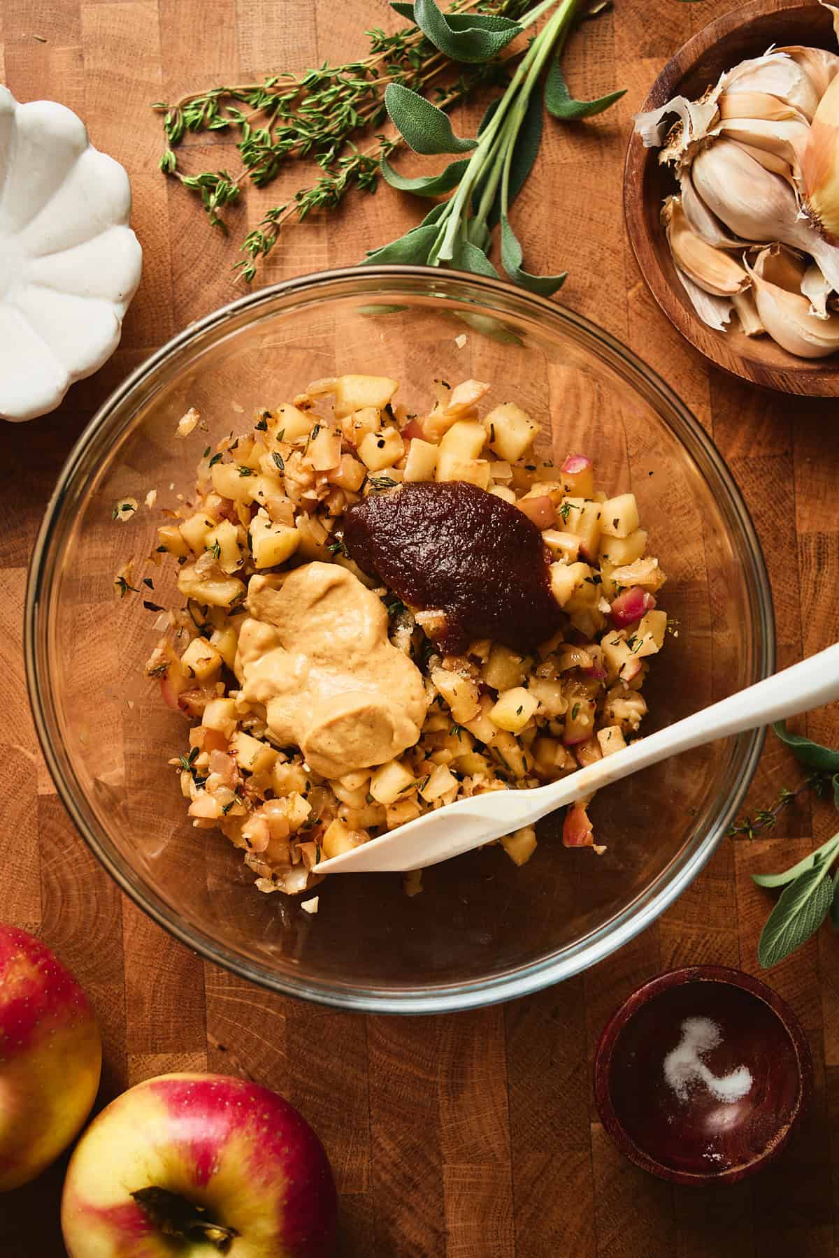 Cooked apples in a bowl with Dijon mustard and apple butter added.