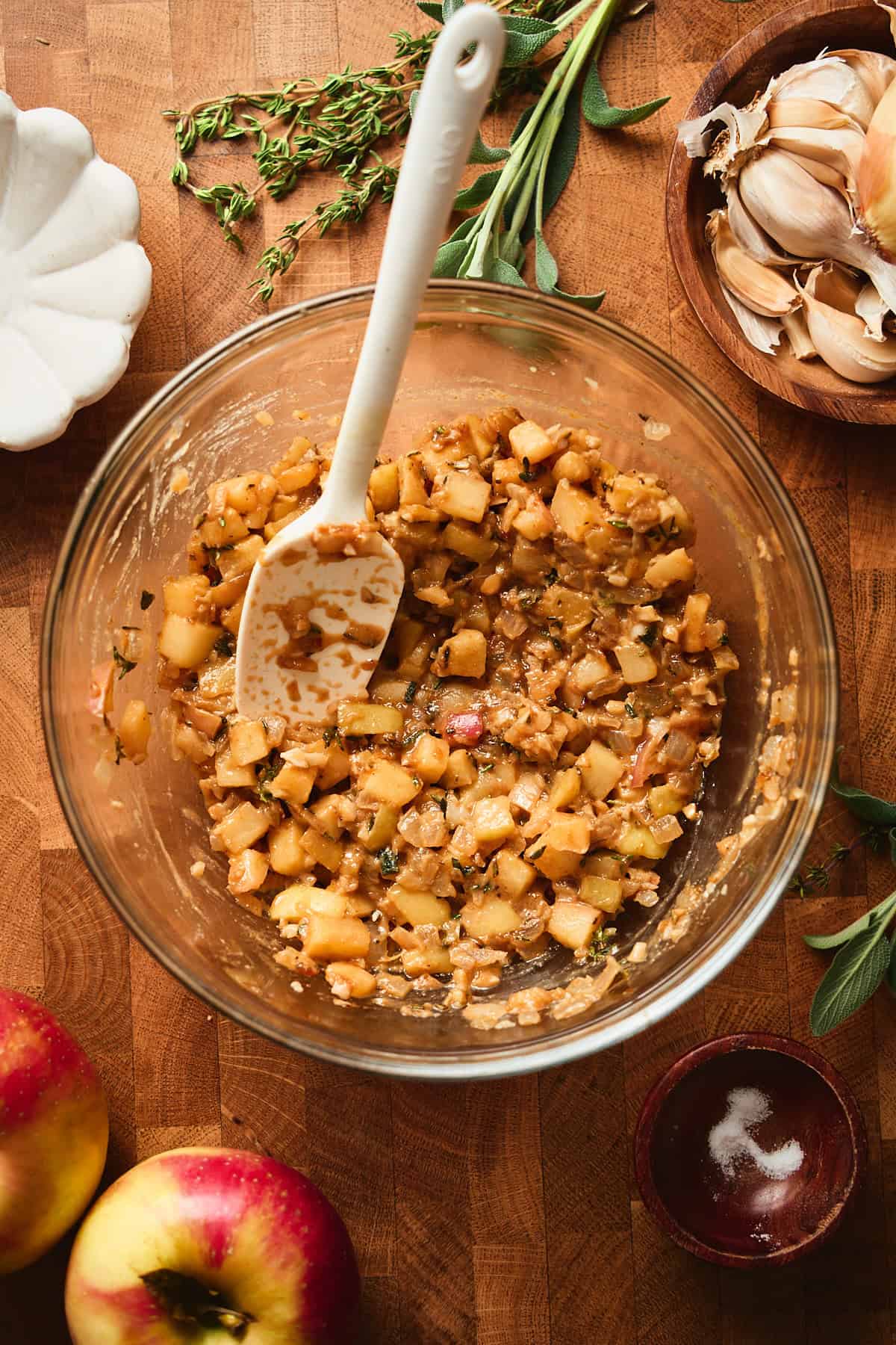 Sweet and savory apple filling in a bowl with a rubber spatula.