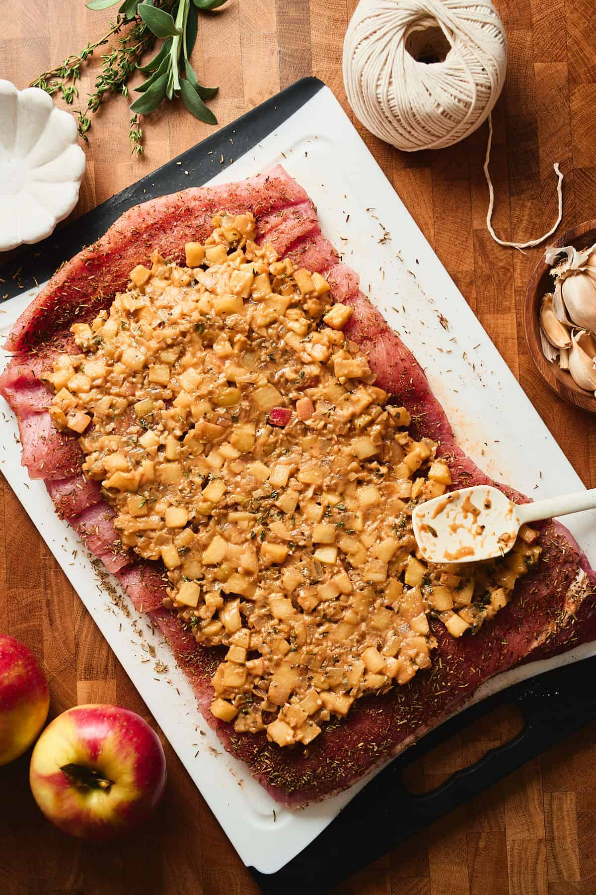 Apple filling spread onto a butterflied pork loin roast.