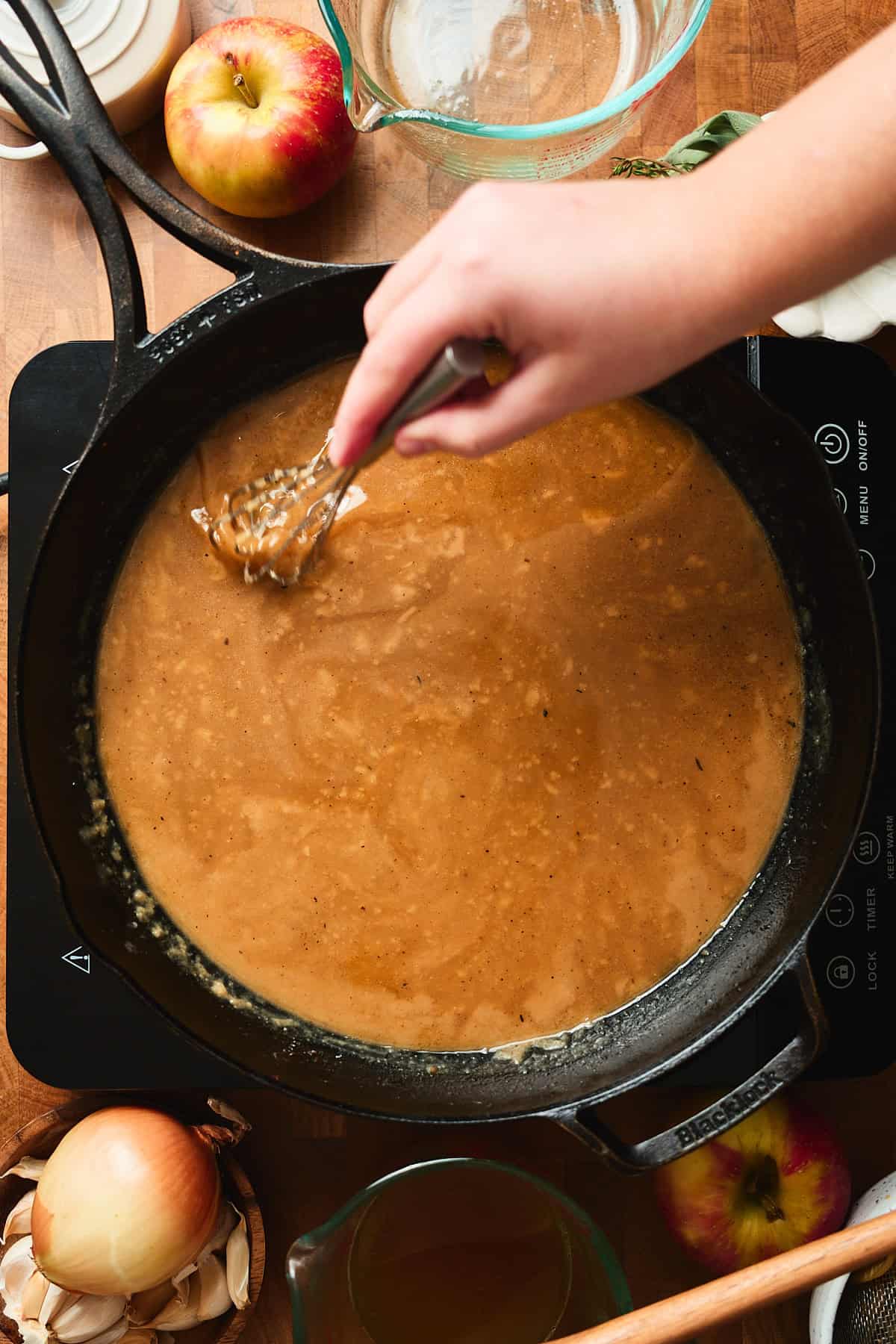 Whisking together a pan gravy with Worcestershire sauce added.