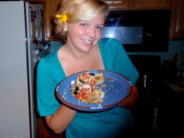 Briana holding a plate with homemade cooked food in her younger highschool days.