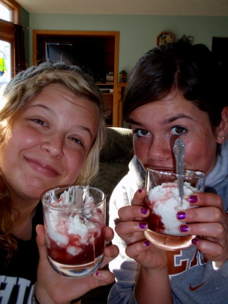 Two women holding glasses of homemade Norwegian style rice pudding.