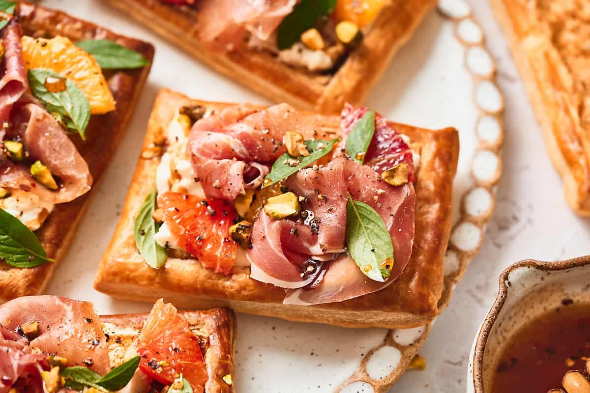 Burrata and Prosciutto Puff Pastry Tarts with Hot Honey & Citrus