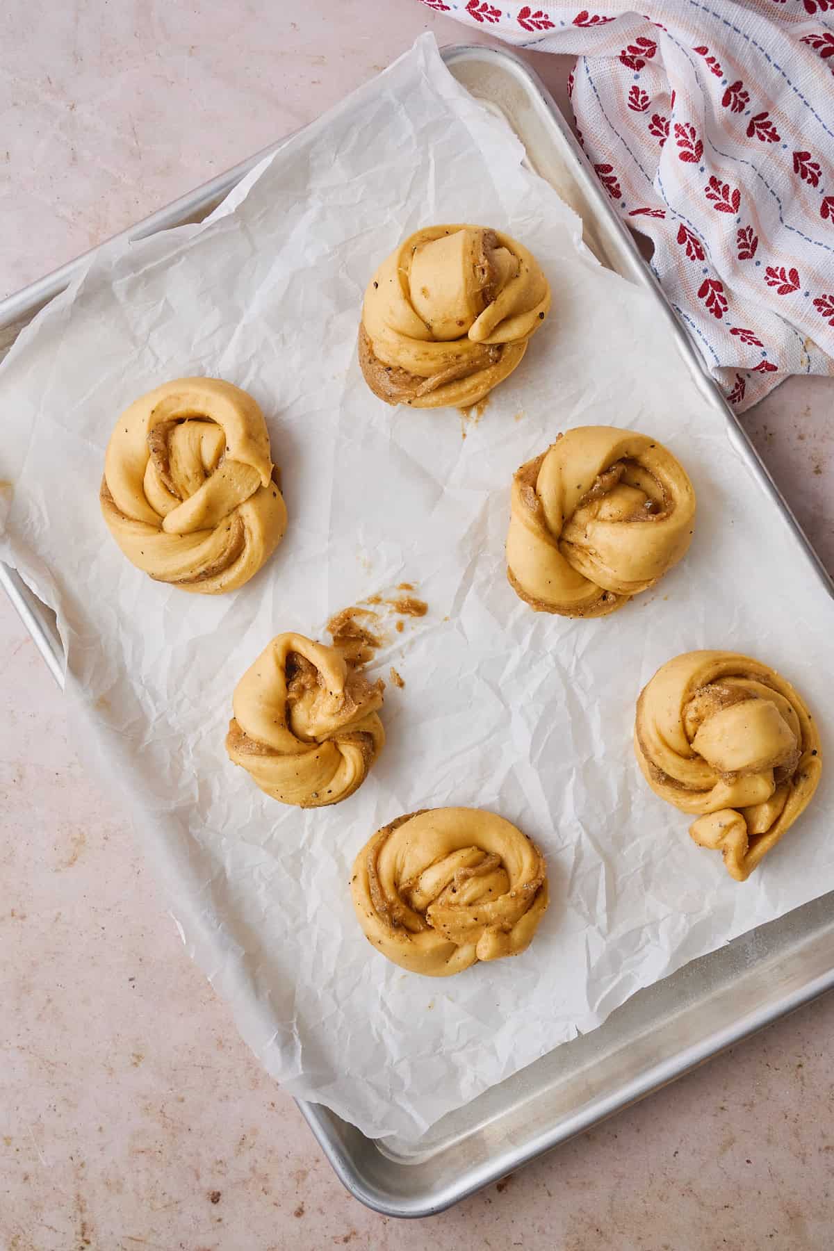 Puffy unbaked buns after a second rise.
