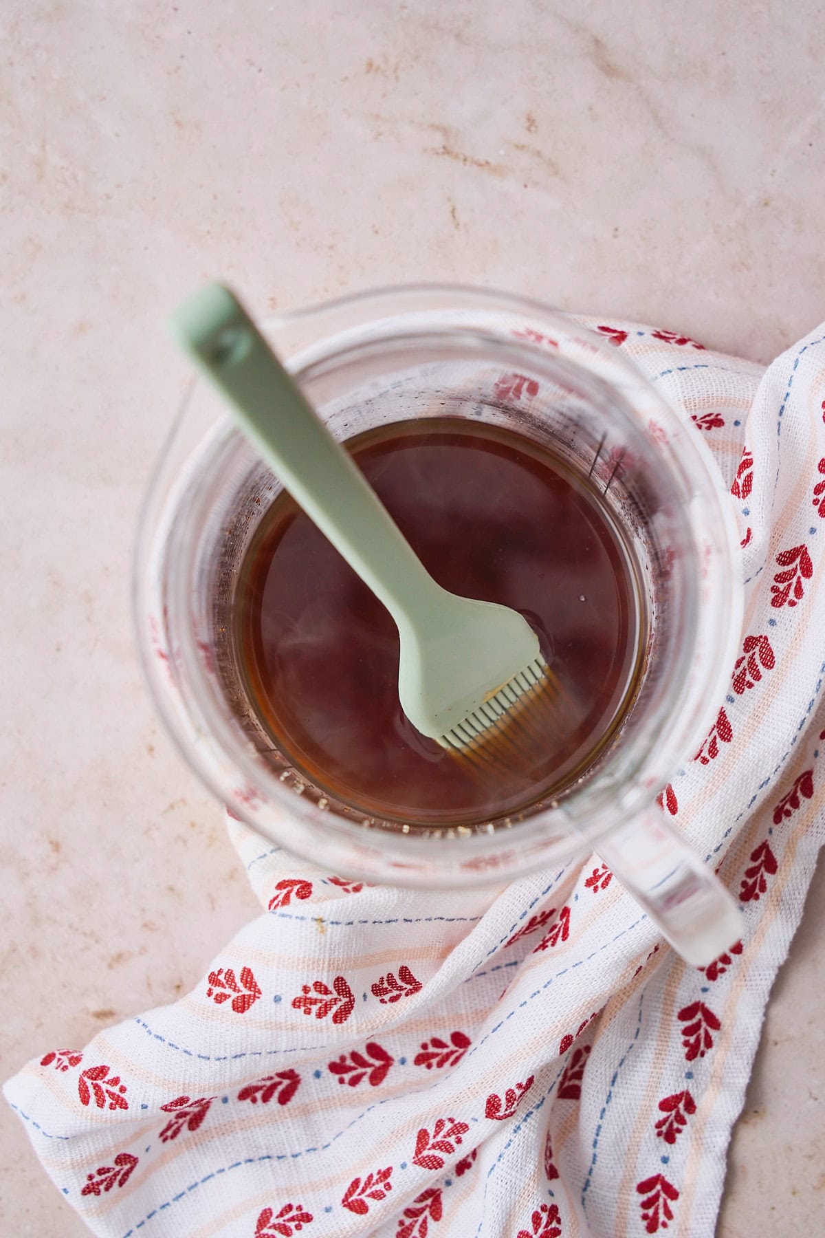 Brown sugar vanilla syrup in a container with a silicone brush.