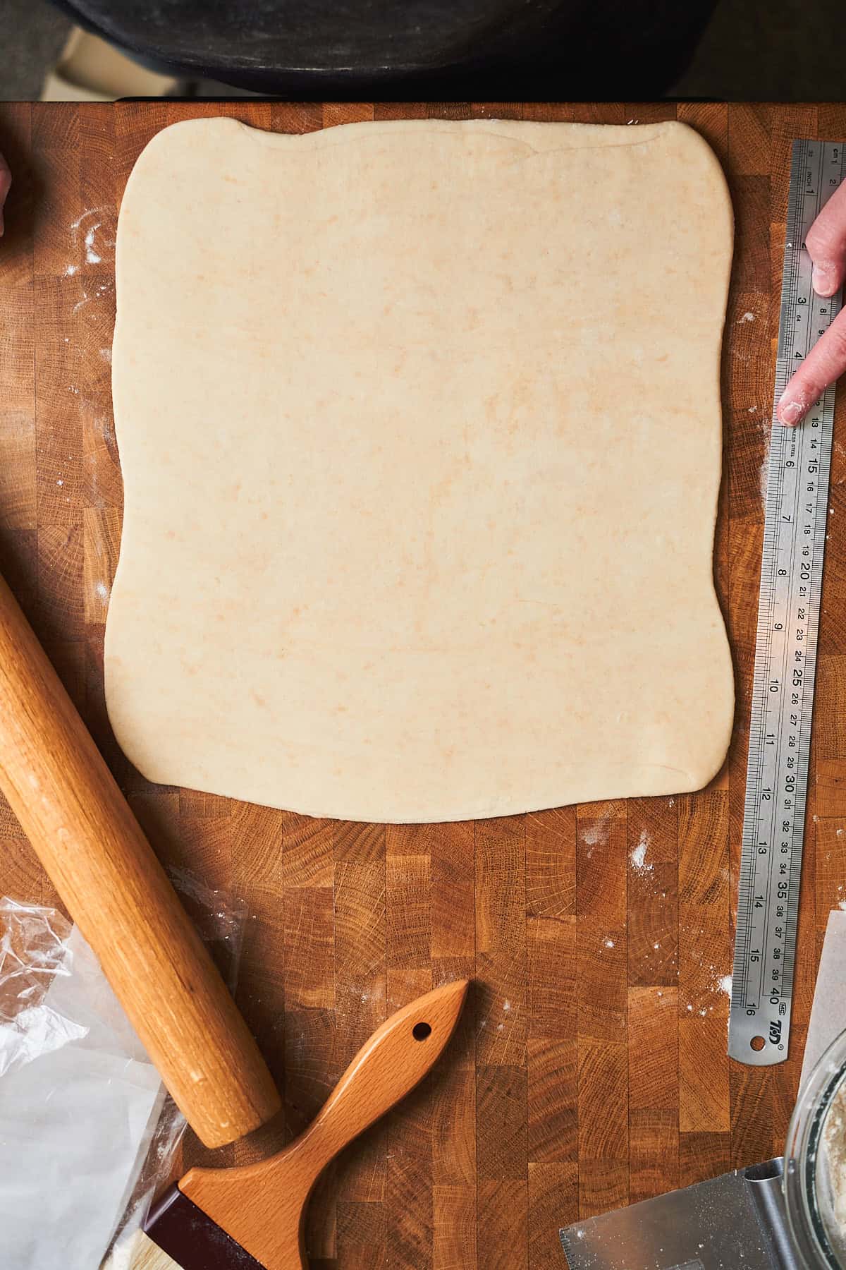 Rolled out sheet of puff pastry on a surface.