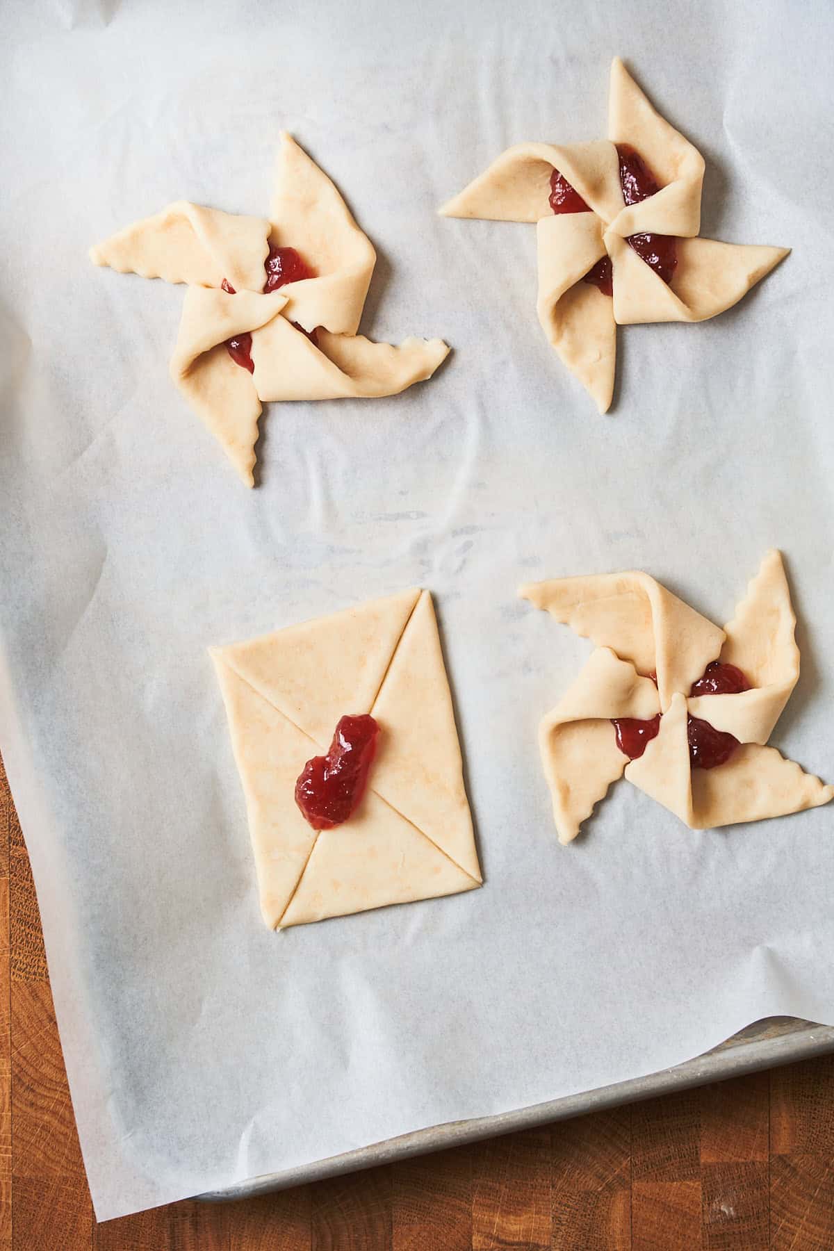 Jam added to the center of puff pastry, with a few of the shapes created into stars.