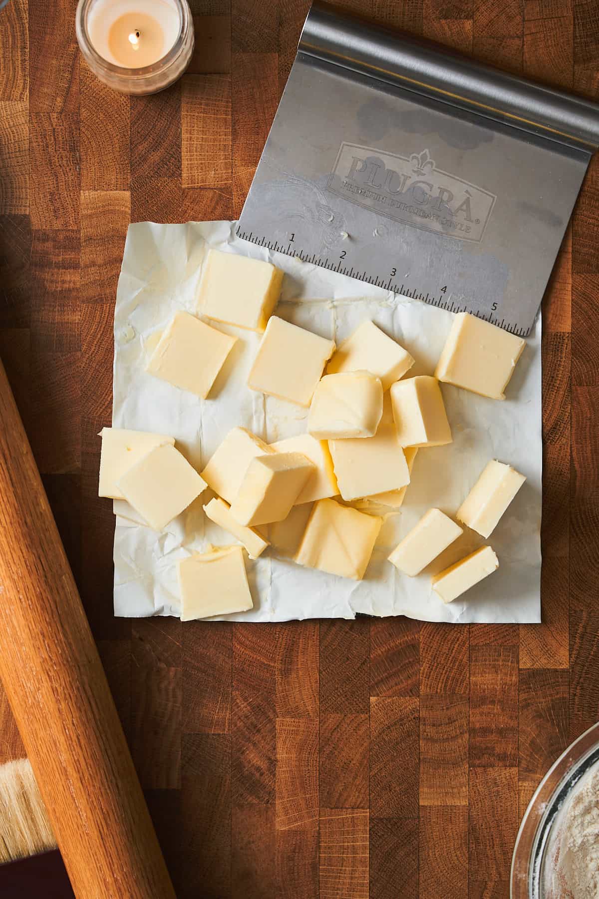 Cubed, cold butter on a surface.