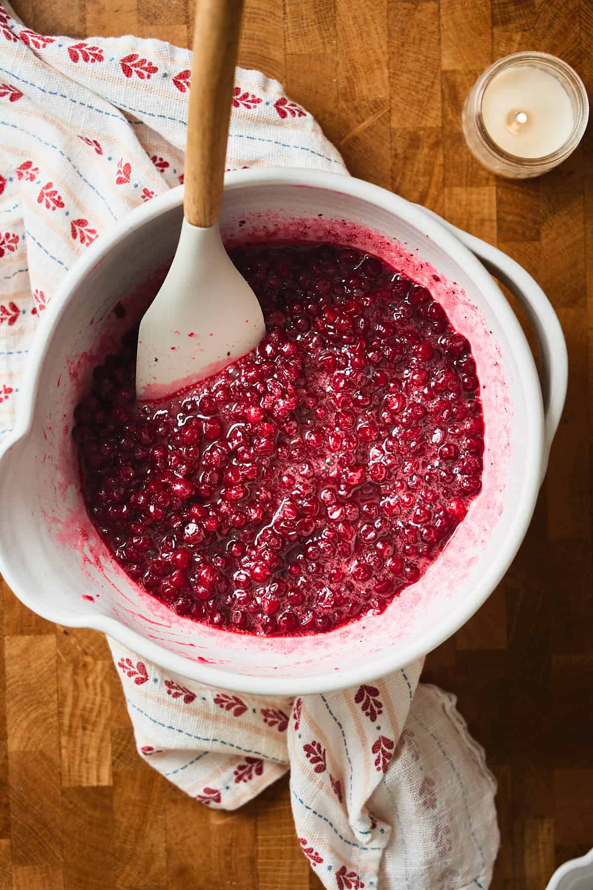 Bowl of lingonberries stirred with sugar that needed to dissolve.