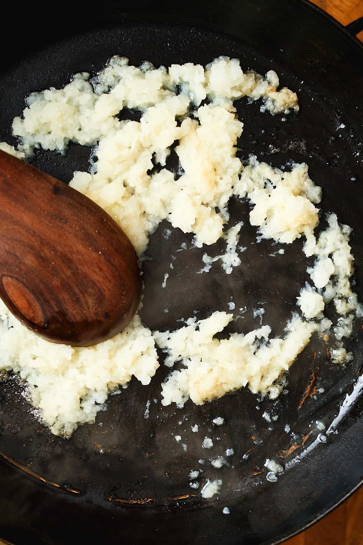 Cooking grated onion in butter in a cast iron skillet.