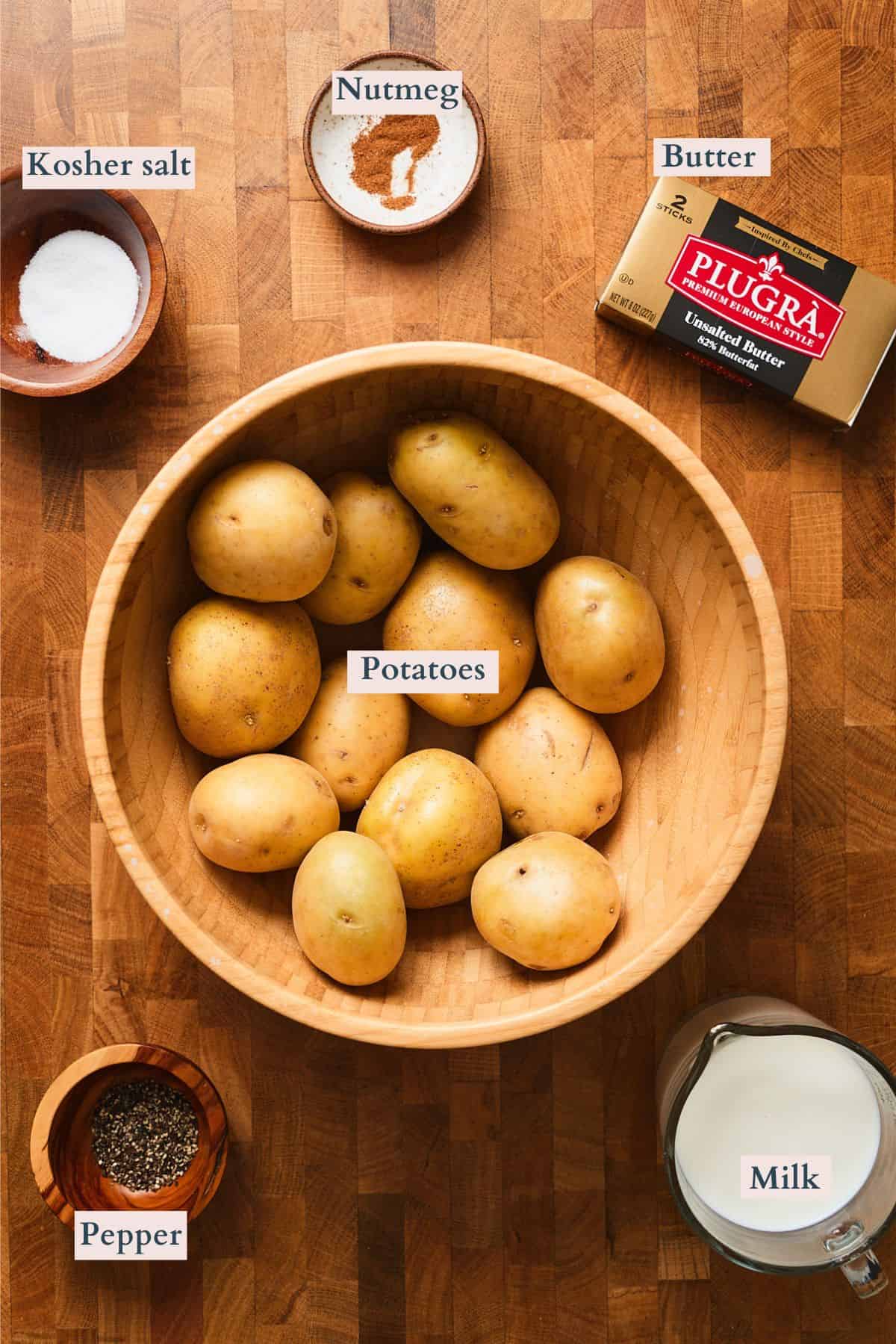 Ingredients to make Swedish style mashed potatoes laid out on a table and labeled to denote each ingredient.